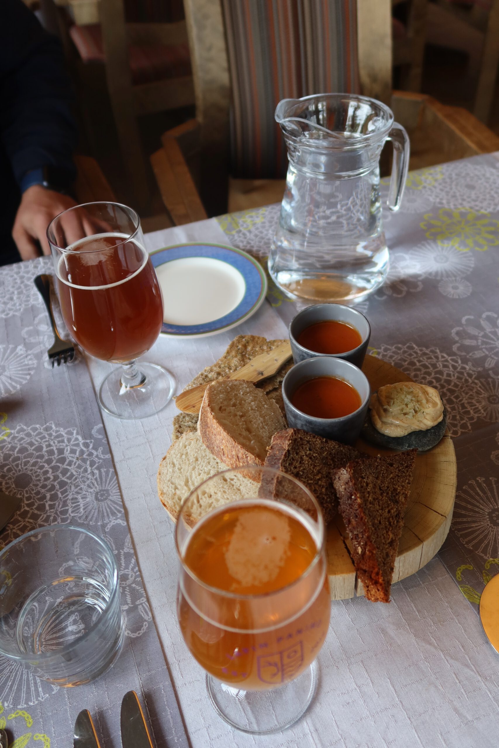 Lapland Hotels Hetta restaurant table with local Finnish beer, bread platter and cozy Lapland dining atmosphere in Enontekiö
