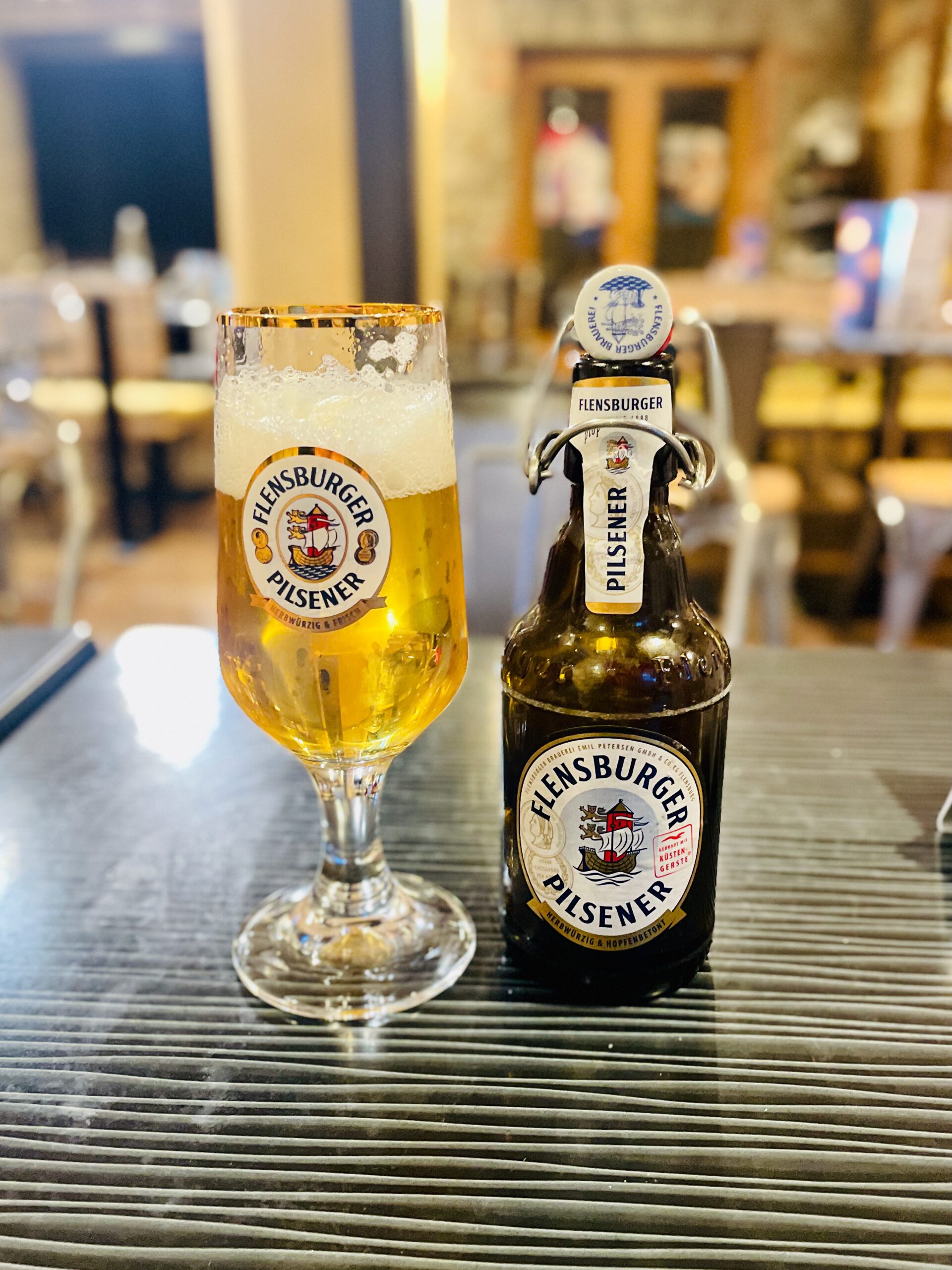 Lachs Räucherei Wortberg Sakura Sushi Wuppertal Flensburger Pilsener beer bottle and glass at the seafood restaurant table