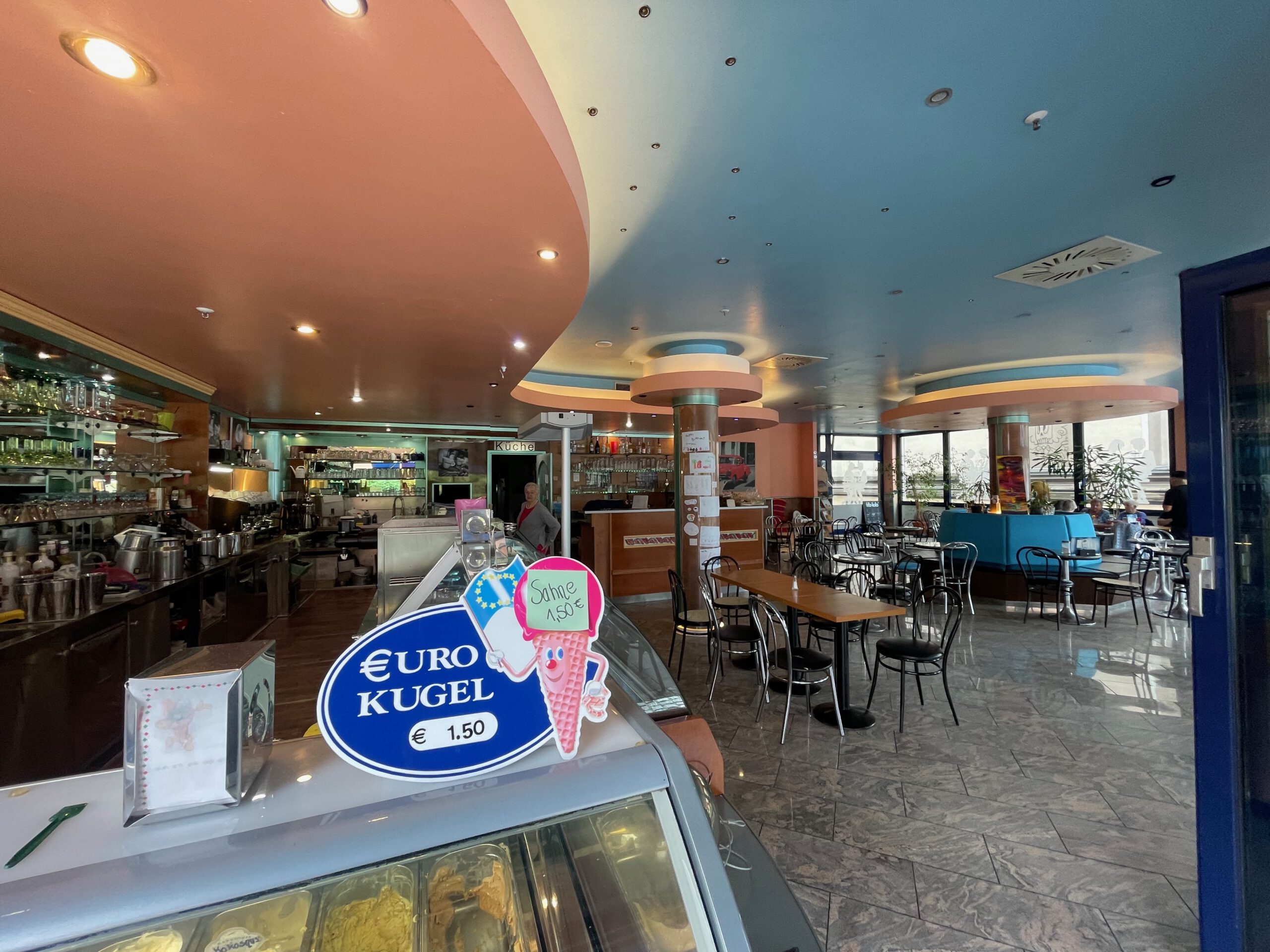 Interior of Eiscafé La Vita Wuppertal showing the large seating area, ice cream counter and relaxed café atmosphere in the city center