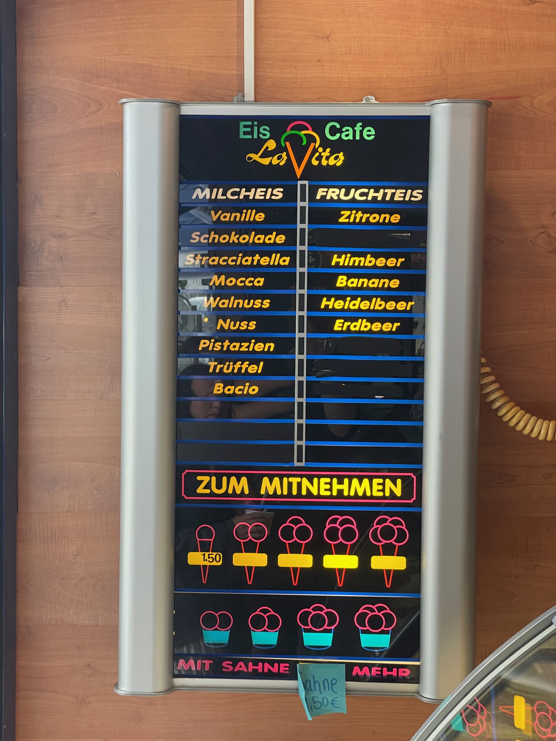 Ice cream menu at Eiscafé La Vita Wuppertal showing milk based and fruit ice cream flavors with clear pricing and take away options