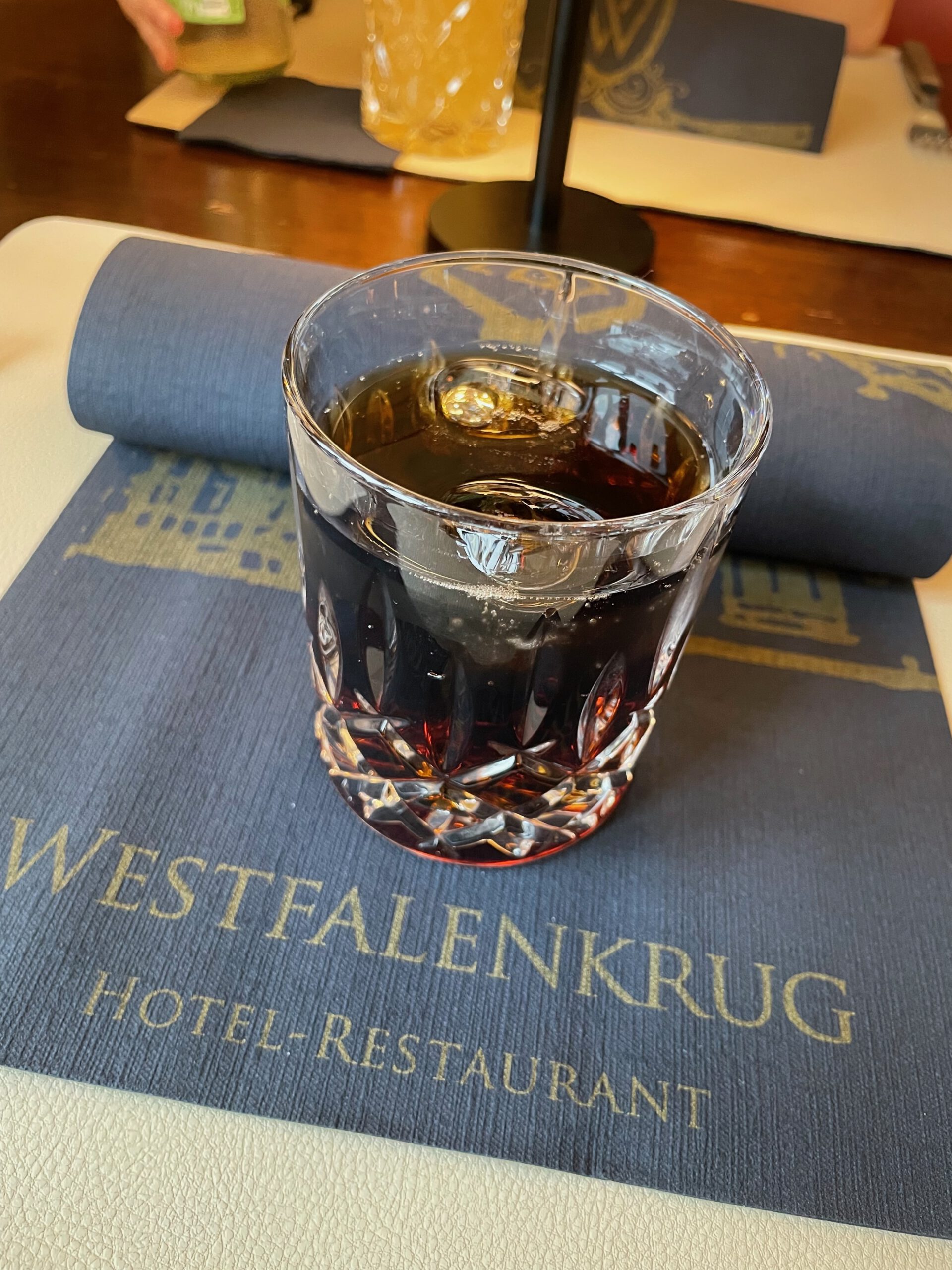Rum and cola drink served at Westfalenkrug Wuppertal hotel restaurant during dinner service