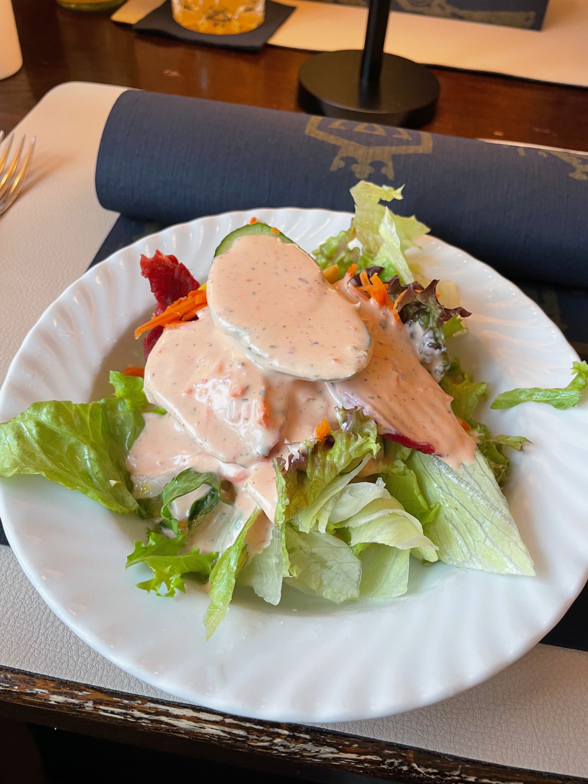 Fresh side salad with creamy dressing served as complimentary starter at Westfalenkrug Wuppertal restaurant