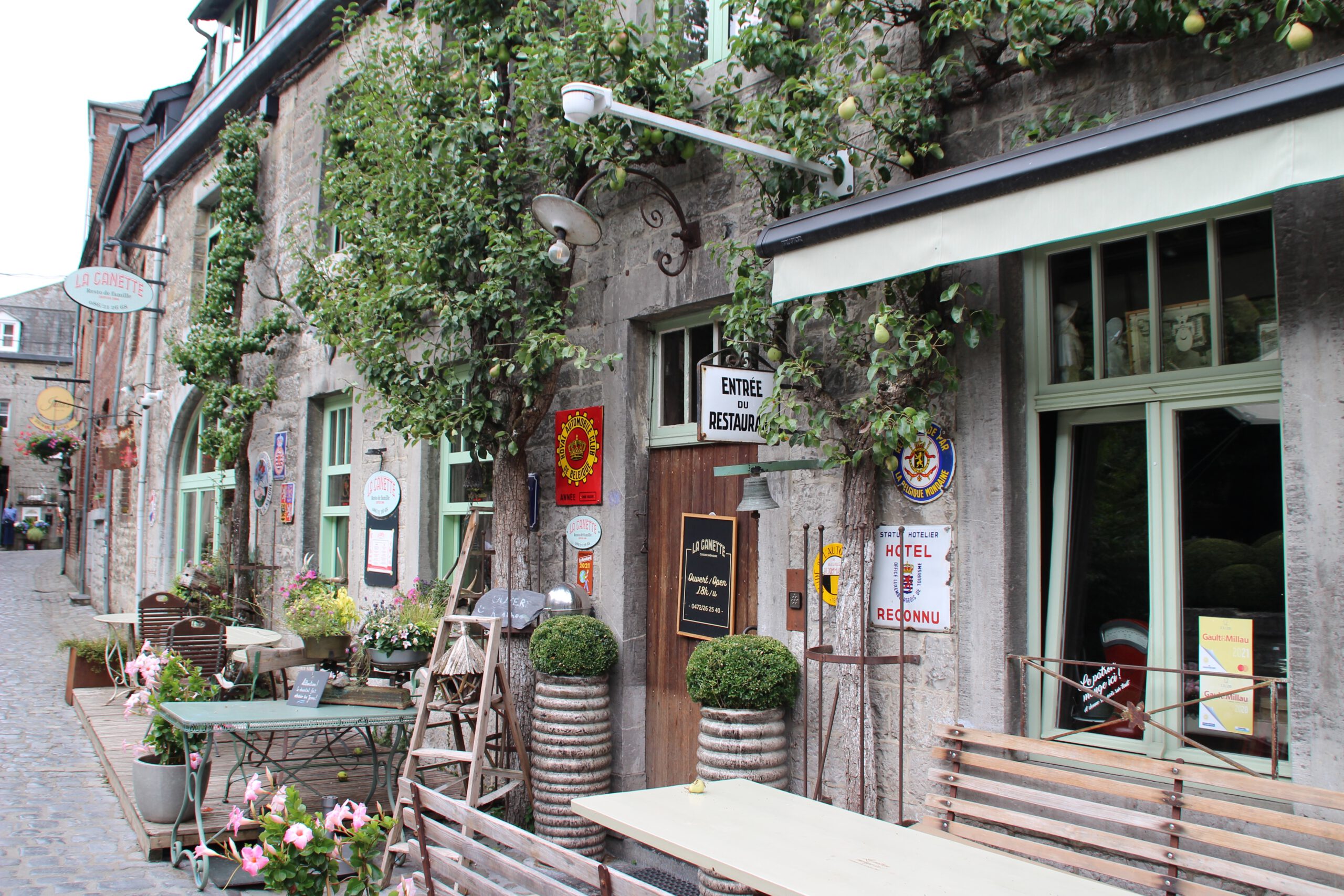 Durbuy travel experience along a charming cobblestone street with a cozy restaurant terrace and historic stone facade in the old town