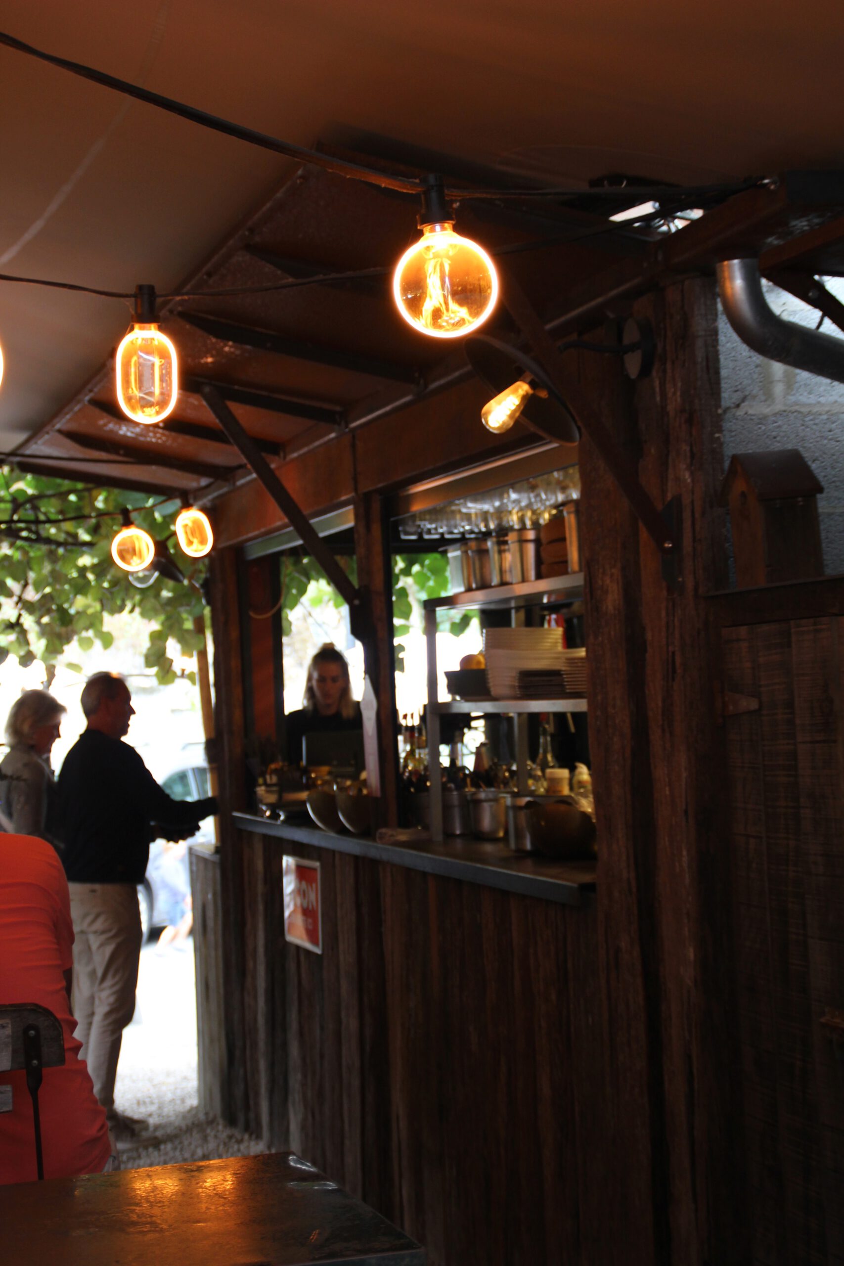 Durbuy travel experience inside a cozy outdoor bar with warm lighting and rustic atmosphere in the historic center