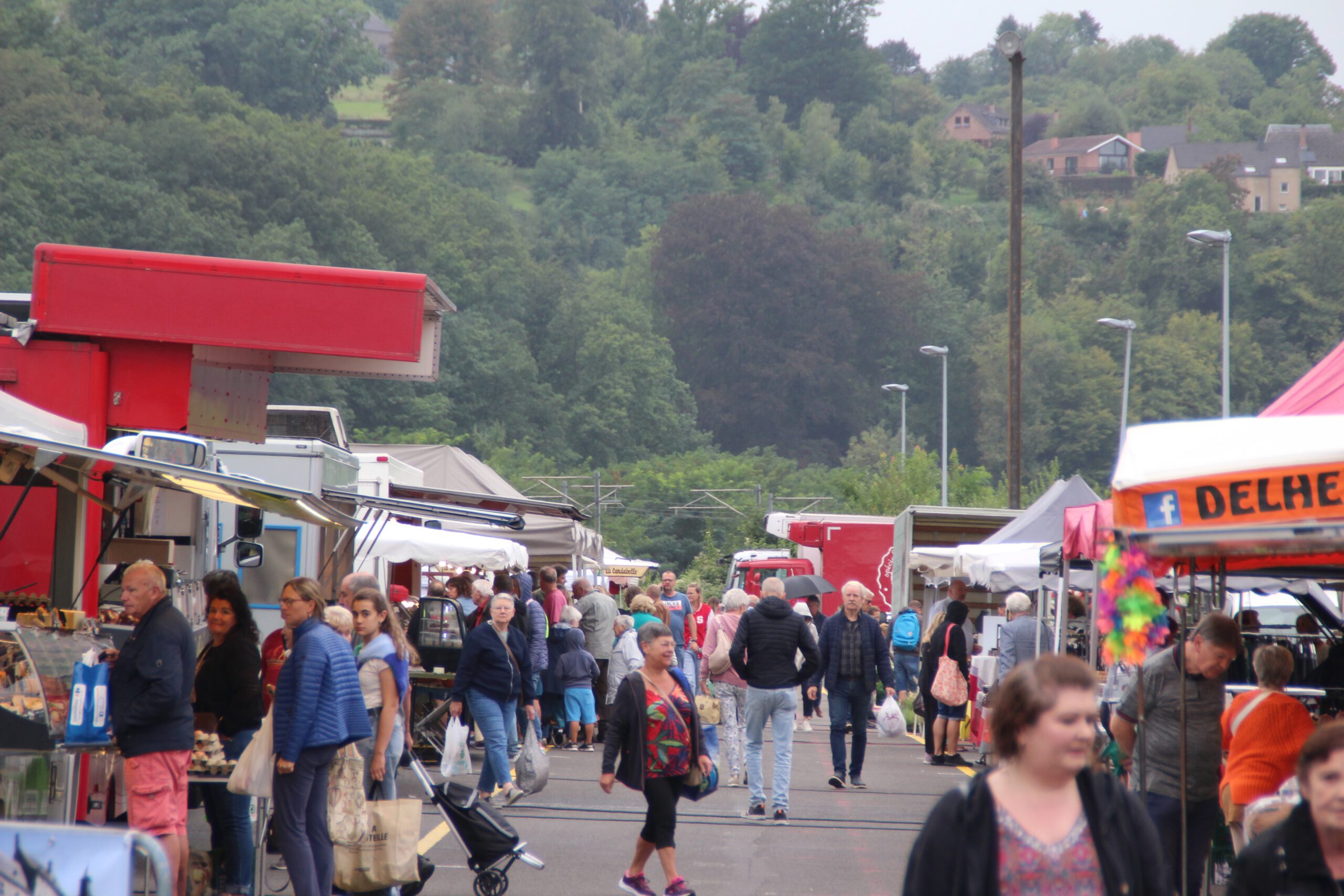 Aywaille Market atmosphere on a busy Saturday morning, with locals browsing fresh produce and artisanal products
