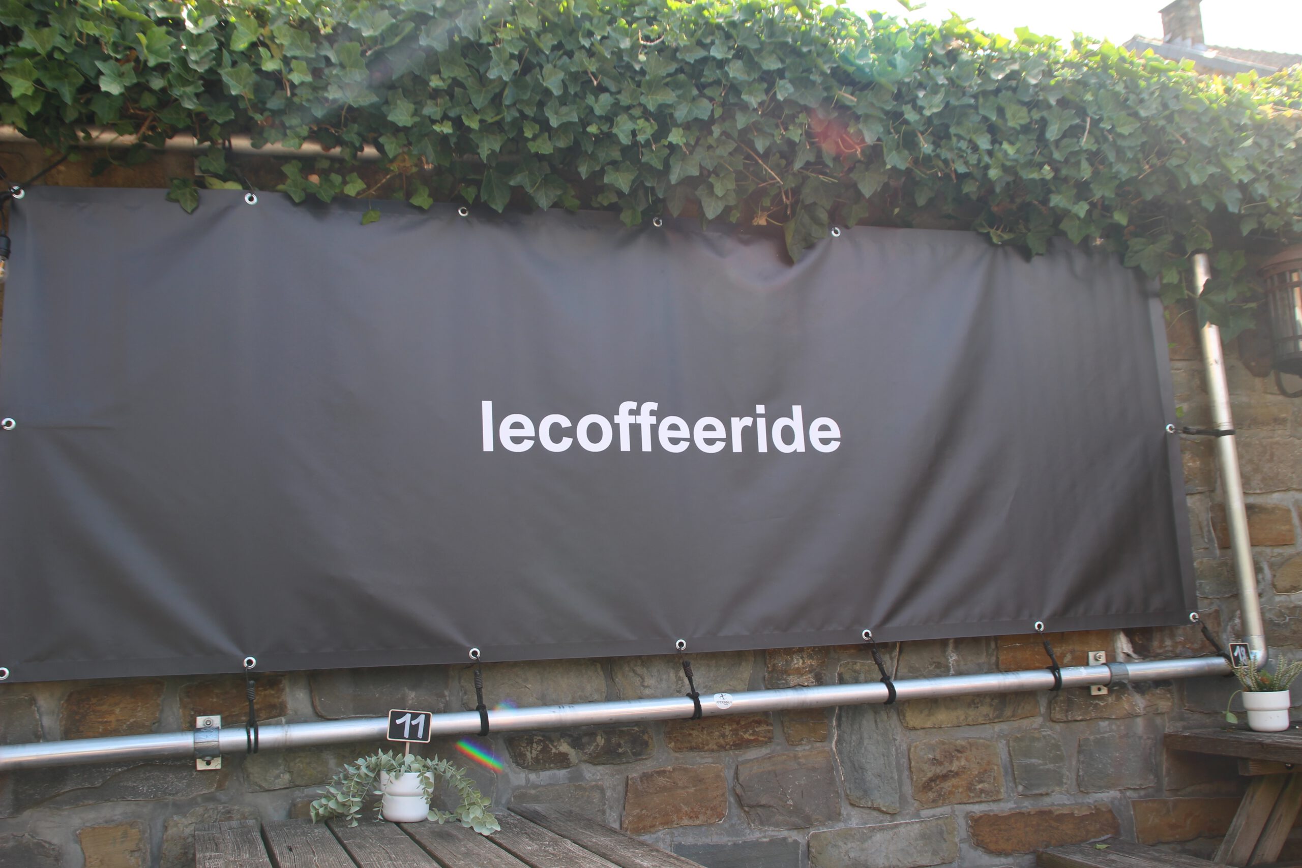 Le Coffee Ride café signage in the Belgian Ardennes, minimalist outdoor cover image of the Le Coffee Ride cycling café in Stavelot