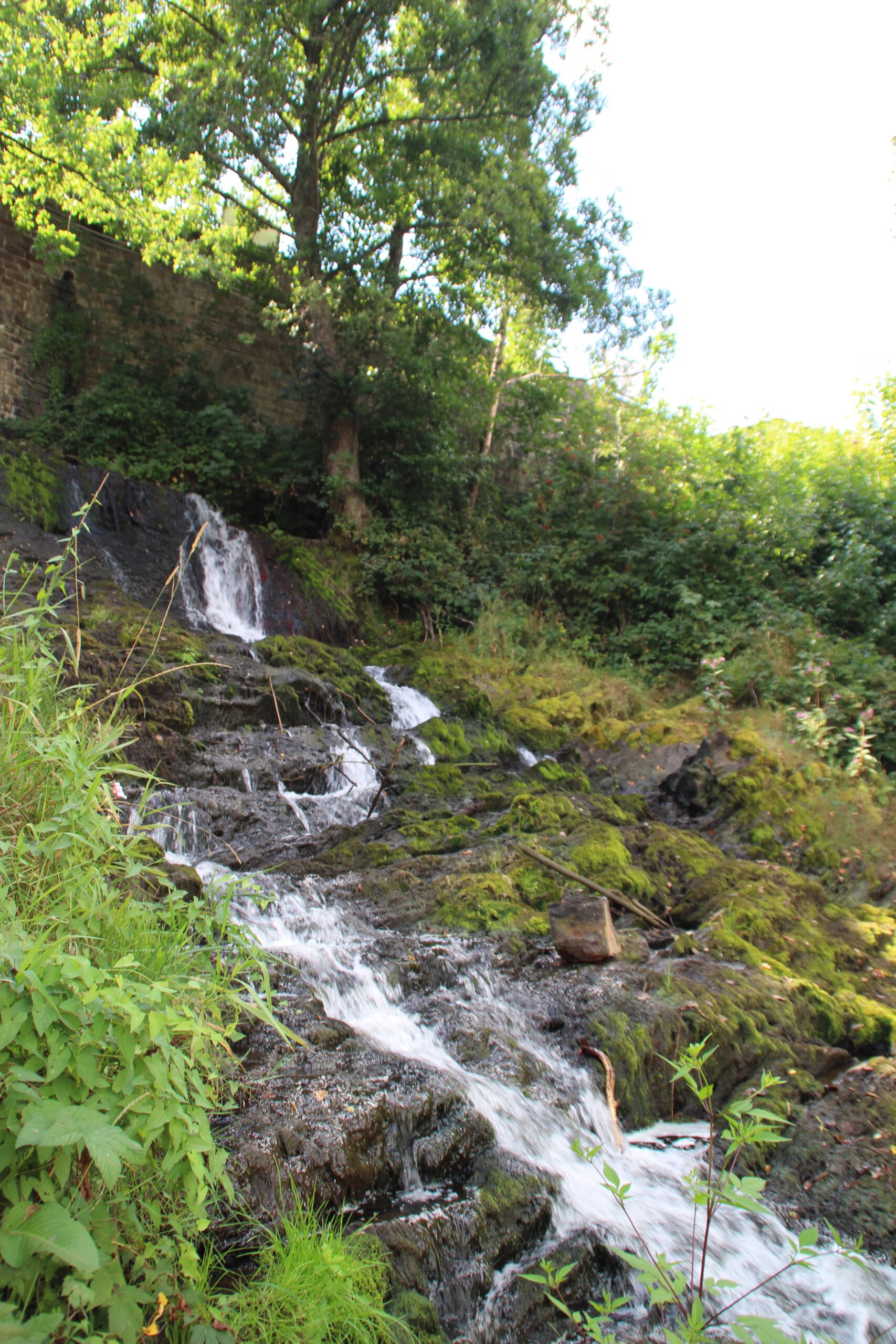 Watervallen of Coo with small cascading waterfall flowing over moss covered rocks in the Belgian Ardennes, natural detail near Coo and Stavelot