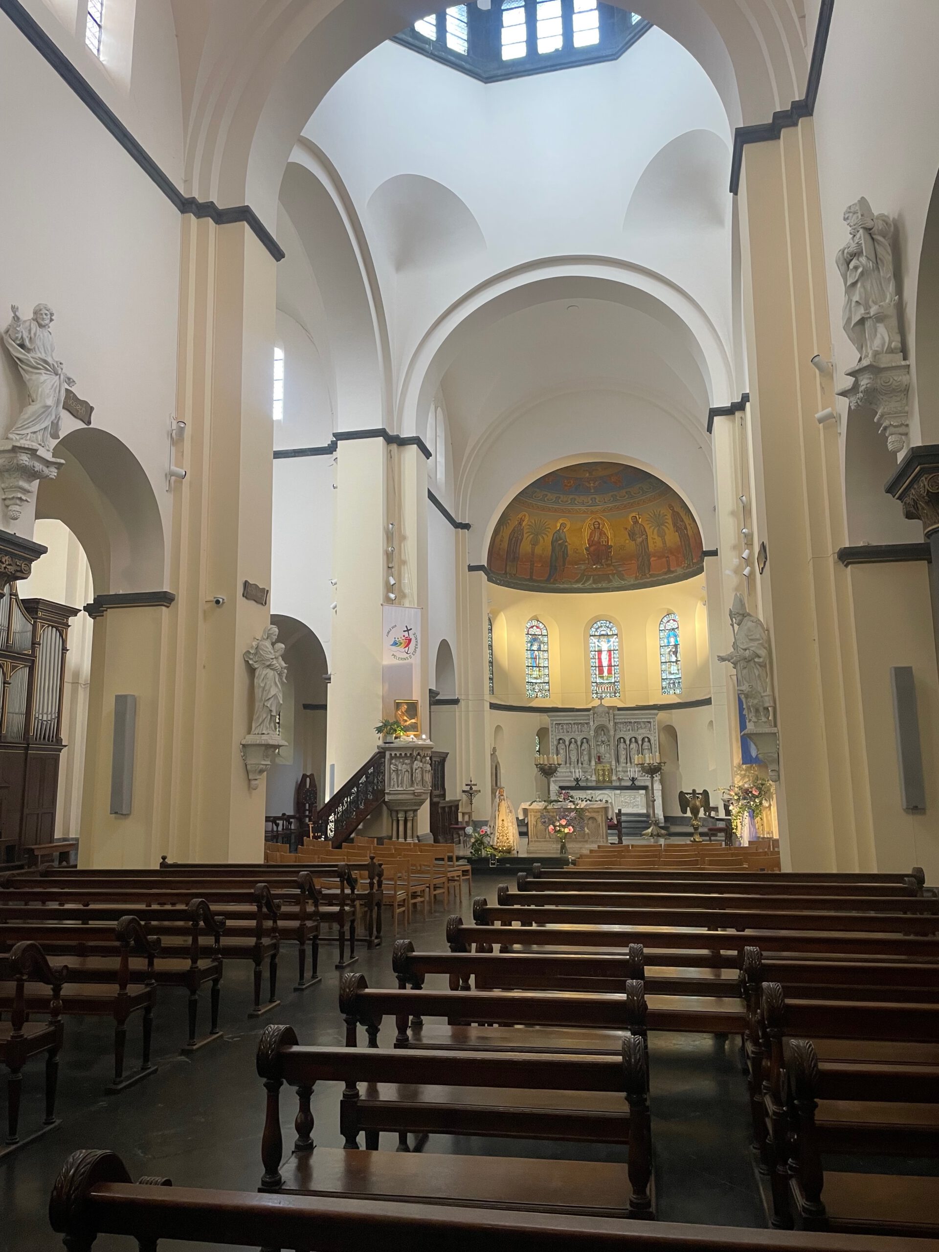Saint Remaclus Church in Spa interior view, wide nave with wooden pews and Roman Catholic altar in the historic church of Spa, Belgium