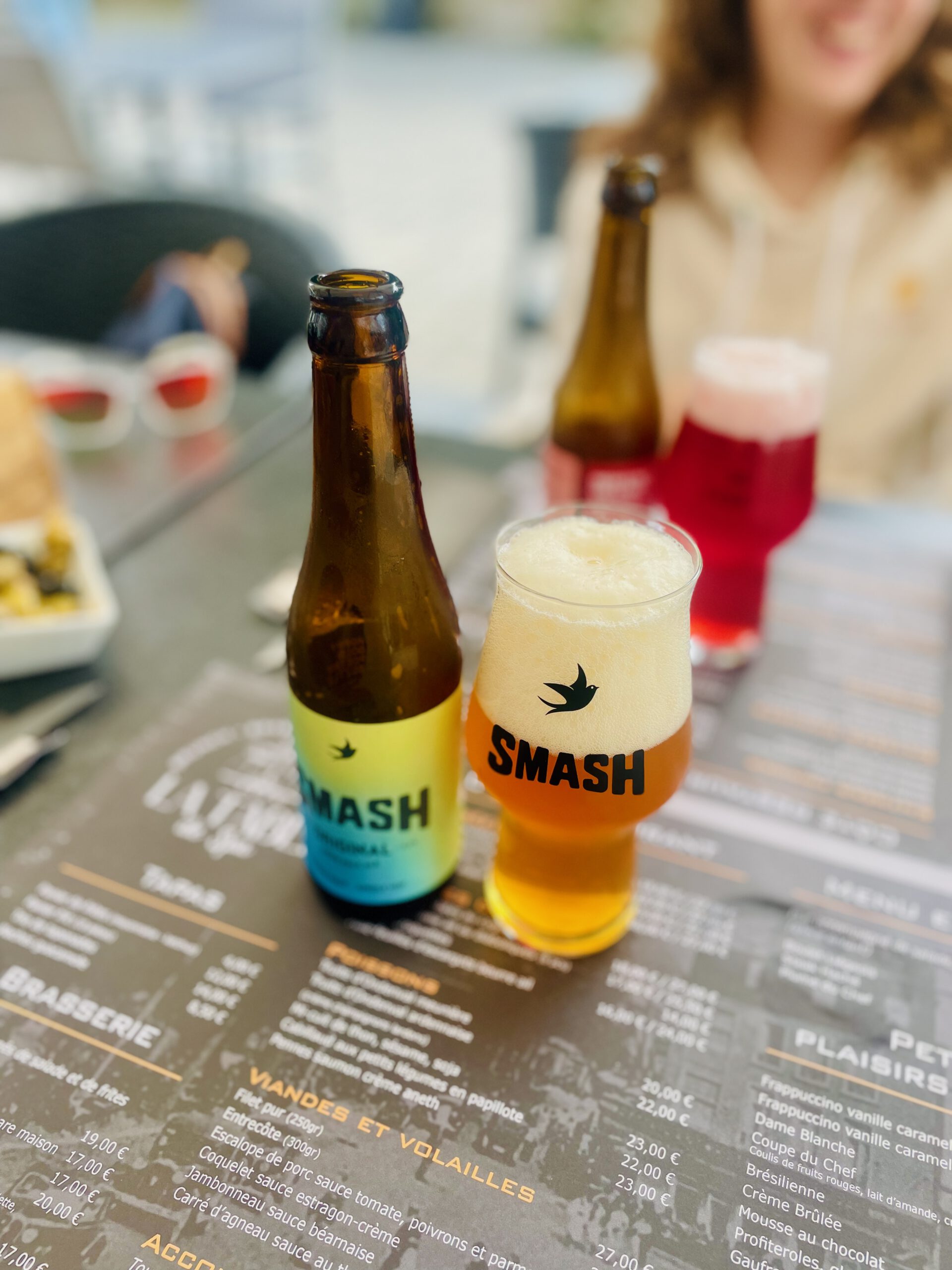 La Table de Spa terrace in Spa Belgium with SMASH Crush beer bottle, casual lunch setting at Belgian brasserie