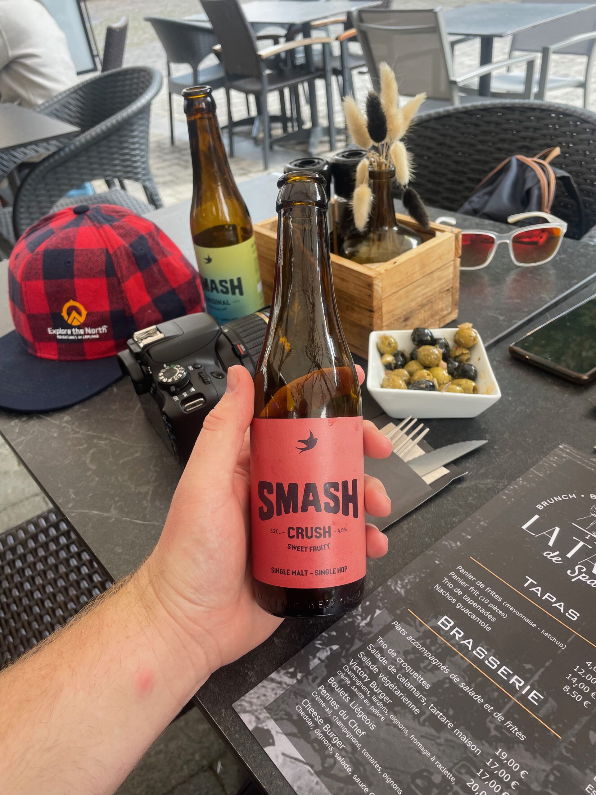 La Table de Spa serving SMASH beer in Spa Belgium, SMASH blond beer bottle and glass on restaurant menu table