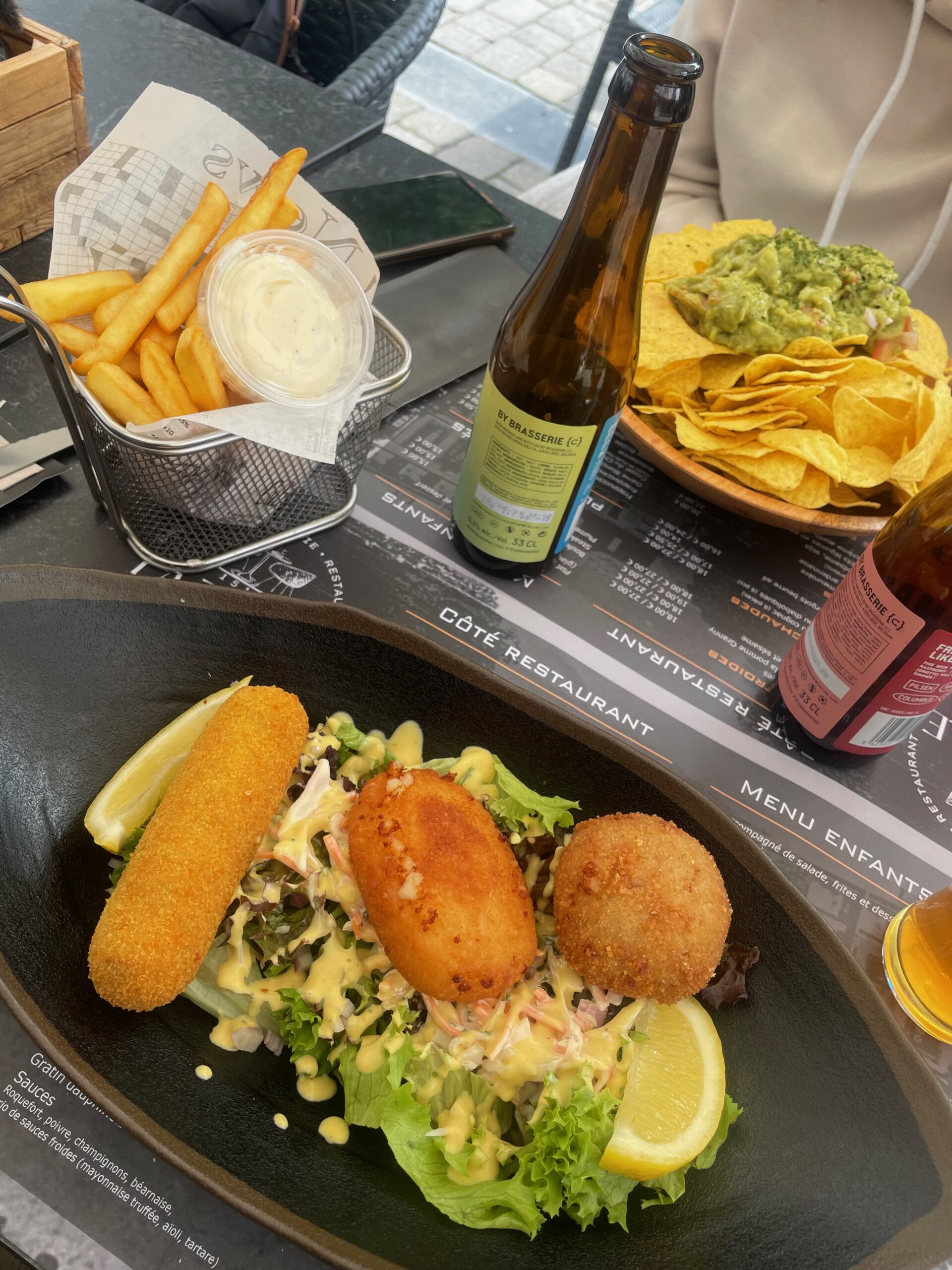 La Table de Spa lunch table in Spa Belgium with croquettes salad, fries, nachos and SMASH beer, casual Belgian brasserie meal