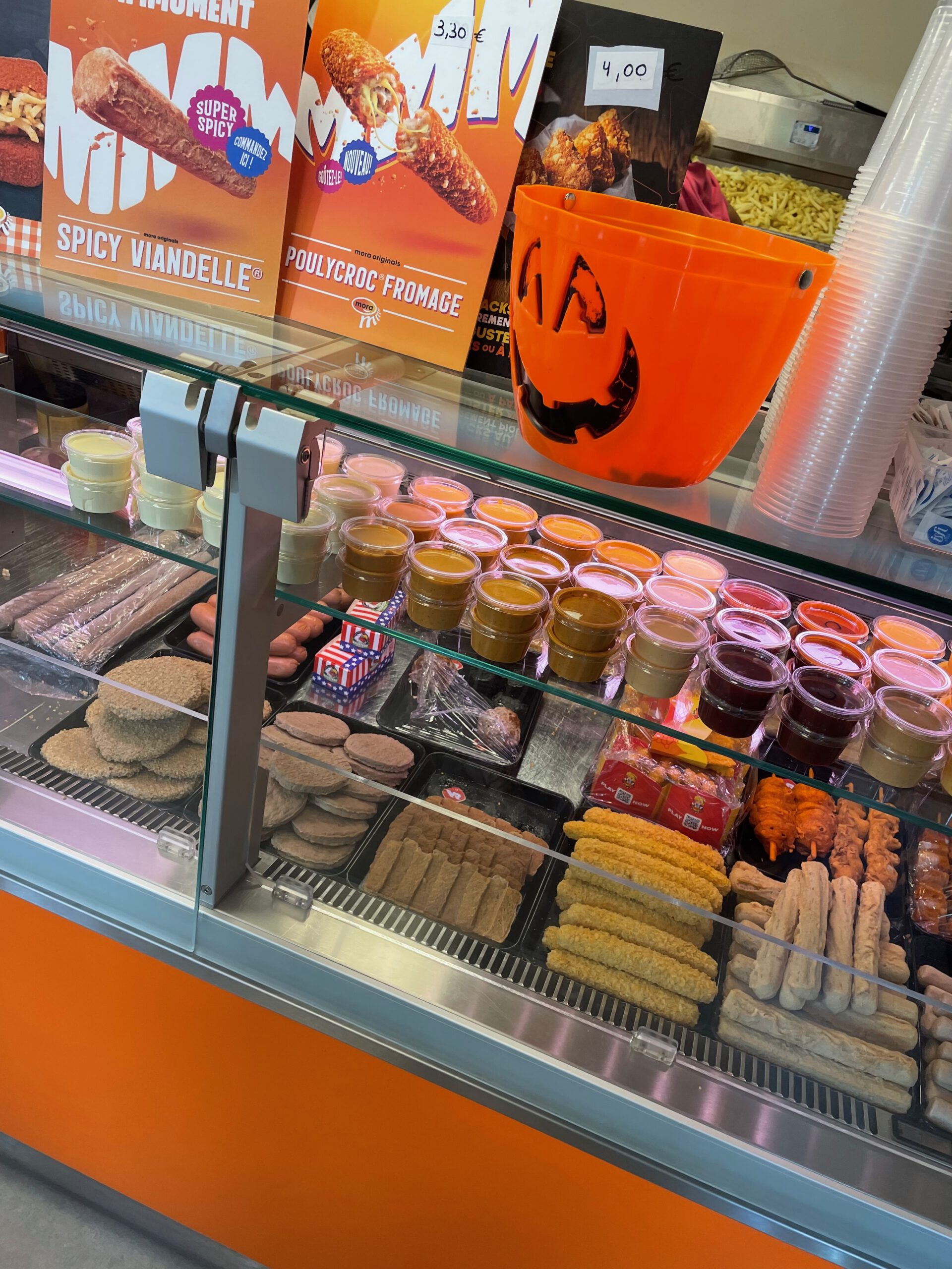 Chez Flo lunch review showcasing the interior of Friterie Chez Flo with snack display, sauces and classic Belgian frituur atmosphere in Sprimont