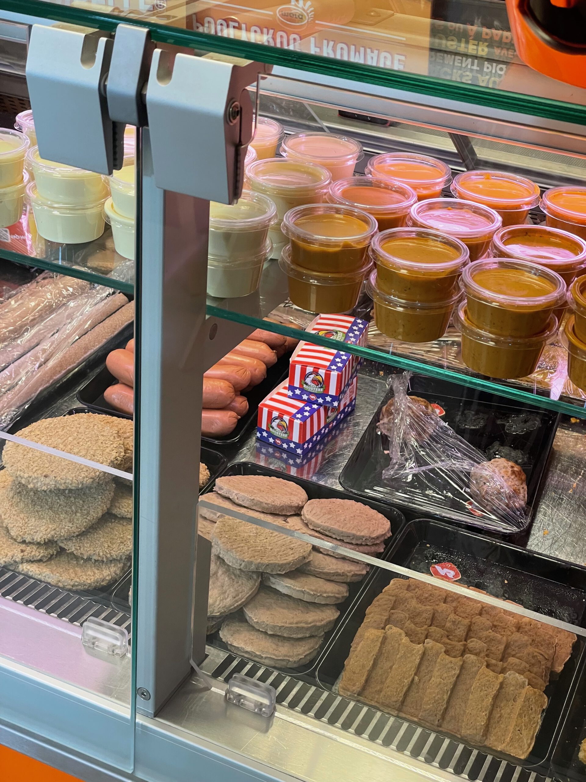 Chez Flo lunch review showing the interior display with Belgian sauces, burgers and traditional frituur snacks inside Friterie Chez Flo in Sprimont