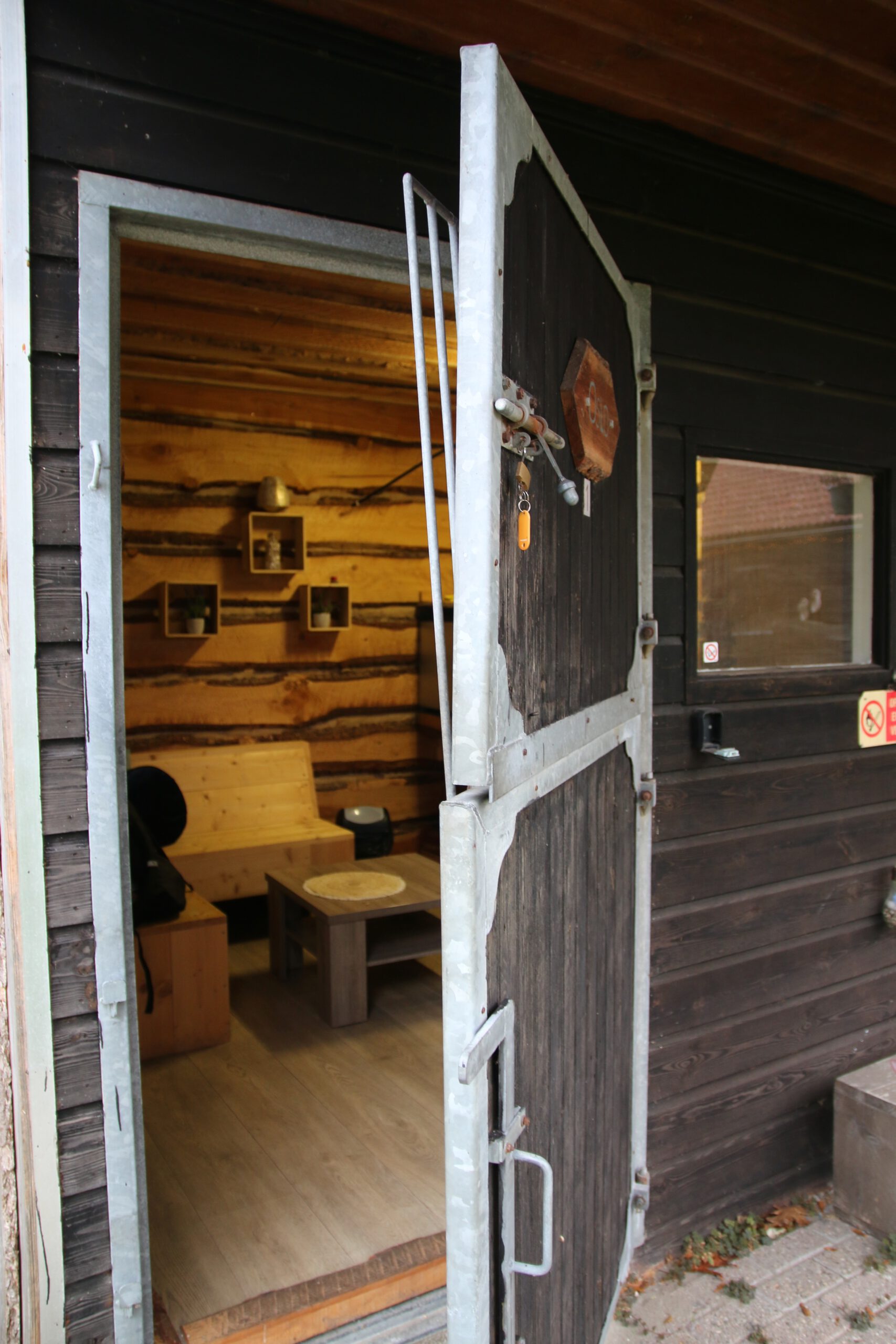 Back To Basic Zwaanshoek rustic stable door opening into a simple wooden guest room