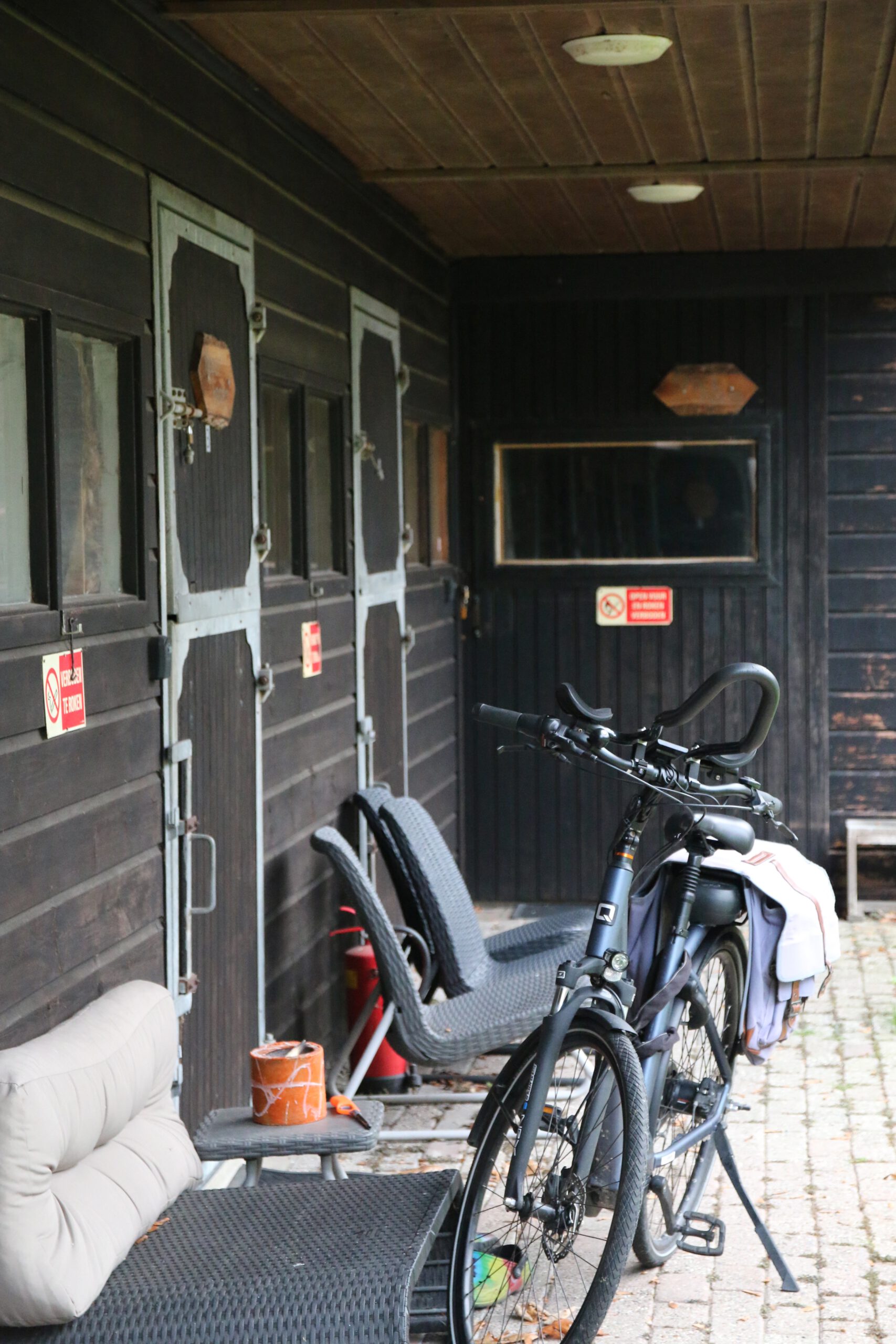 Back To Basic Zwaanshoek outdoor seating area with rustic stable doors and bicycles on the property