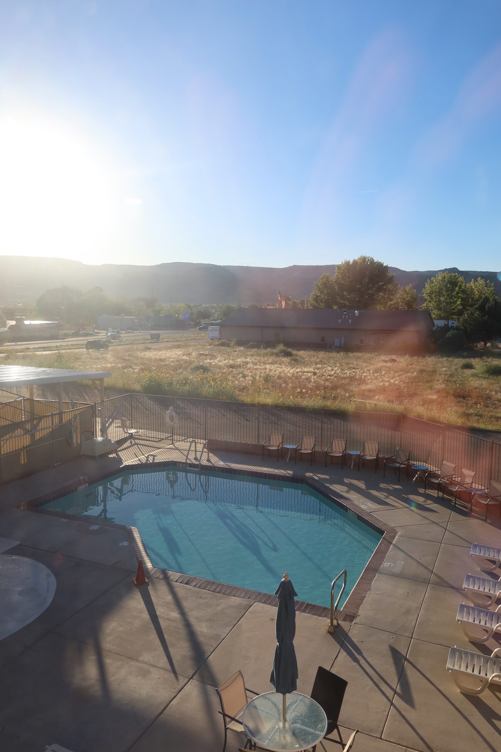 Outdoor swimming pool at Quality Inn Kanab National Park Area with views of red rock hills and surrounding landscape in Kanab, Utah