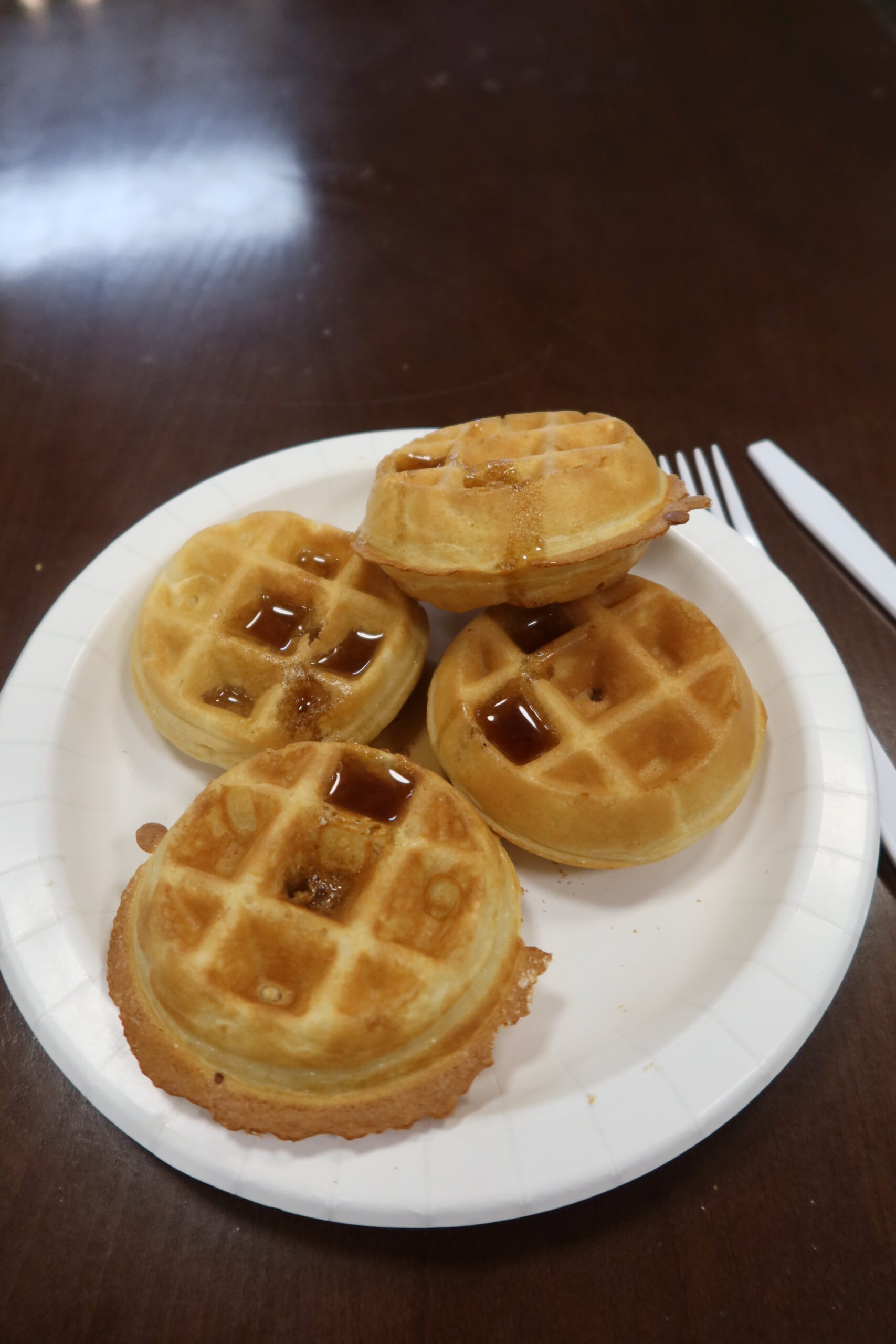 Freshly made breakfast waffles with syrup served at Quality Inn Kanab National Park Area in Kanab, Utah