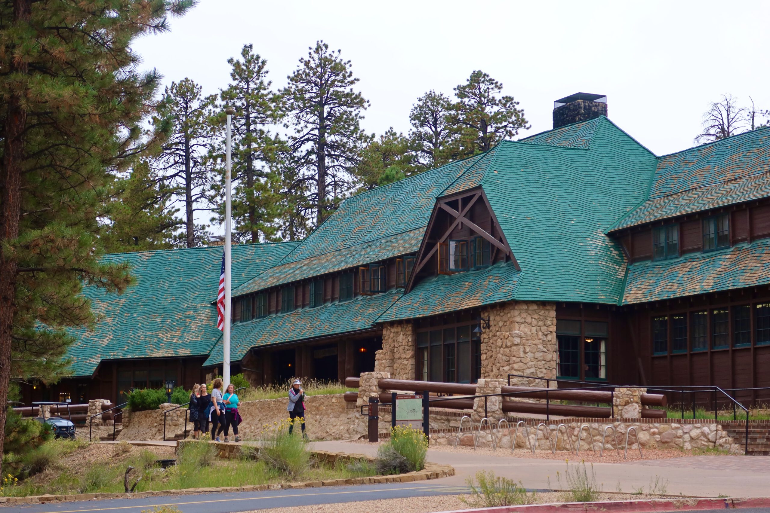 Exterior of The Lodge at Bryce Canyon with green roof and stone facade, historic lodge located inside Bryce Canyon National Park in Utah