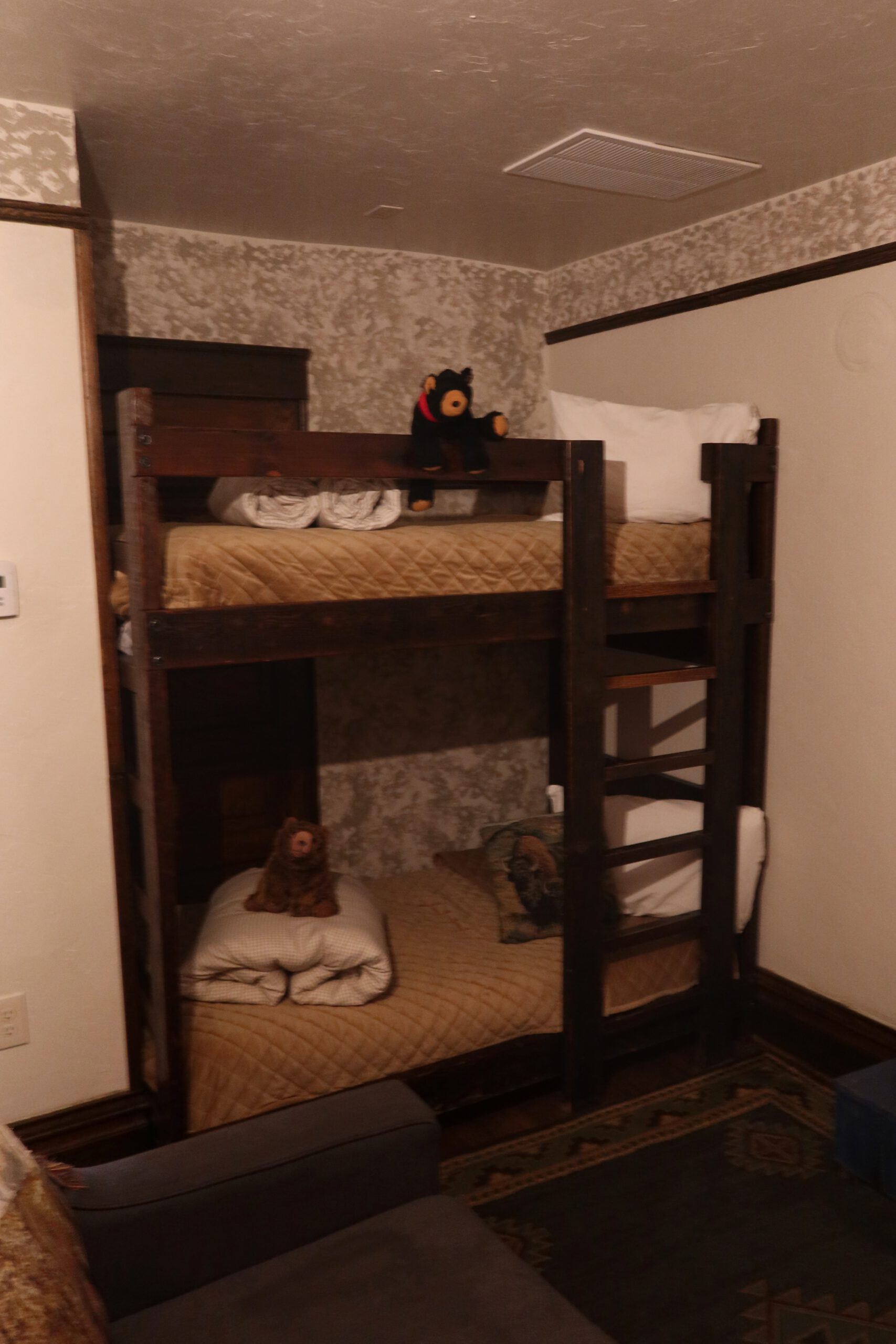 Bunk bed setup in room 201 at Park Hotel Yellowstone in Gardiner Montana, western style hotel room with wooden bunk beds