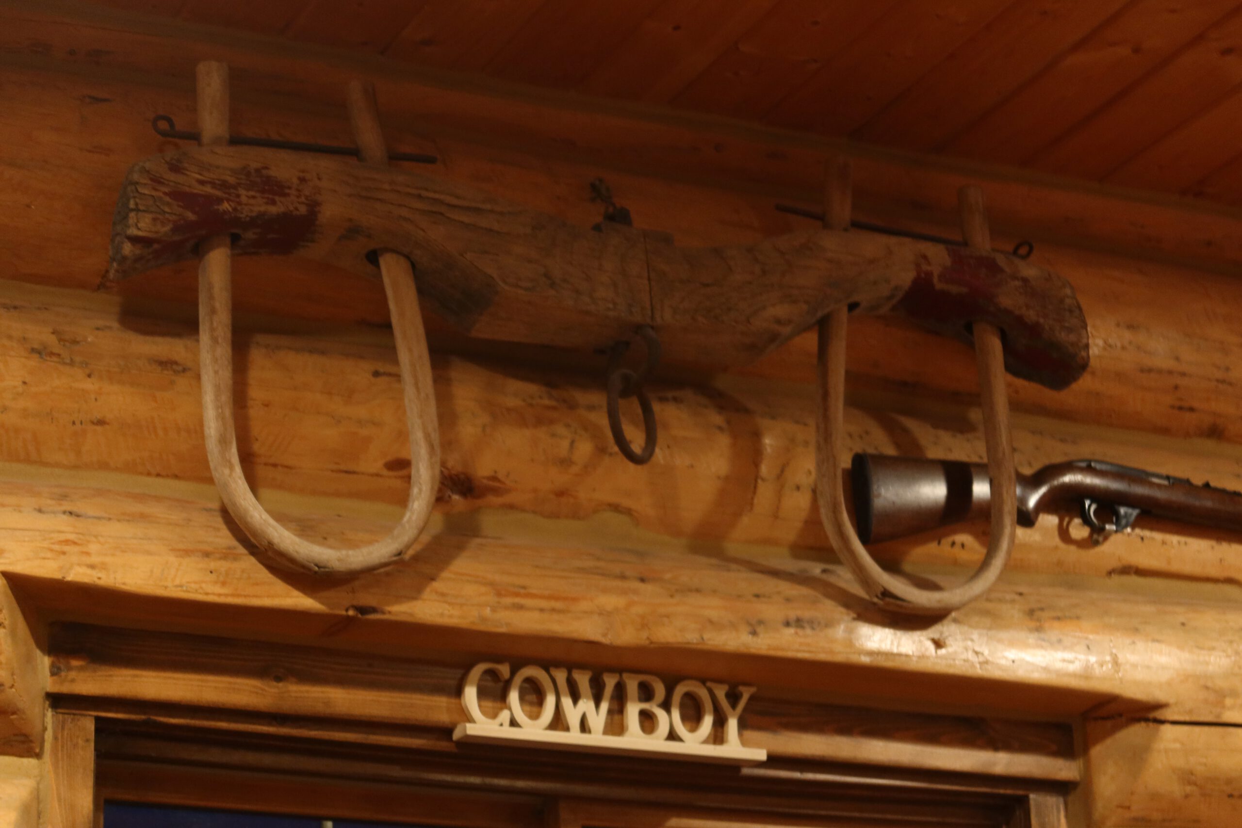 Authentic cowboy decor with wooden yokes and rustic Western details inside Cowboy’s Lodge and Grille Gardiner Montana
