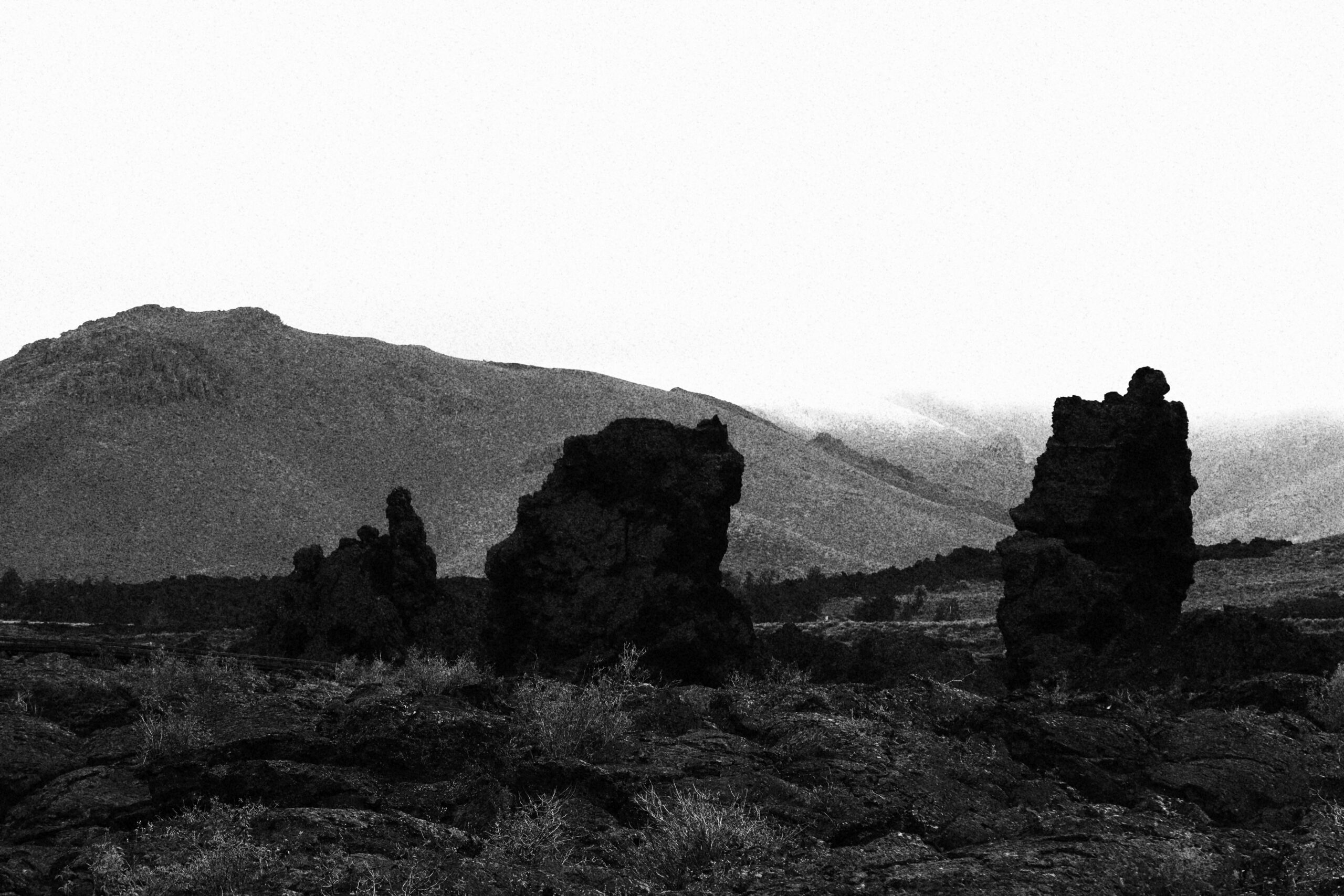 Black and white view of lava rock formations at Craters of the Moon National Monument, showing the rugged volcanic landscape in Idaho