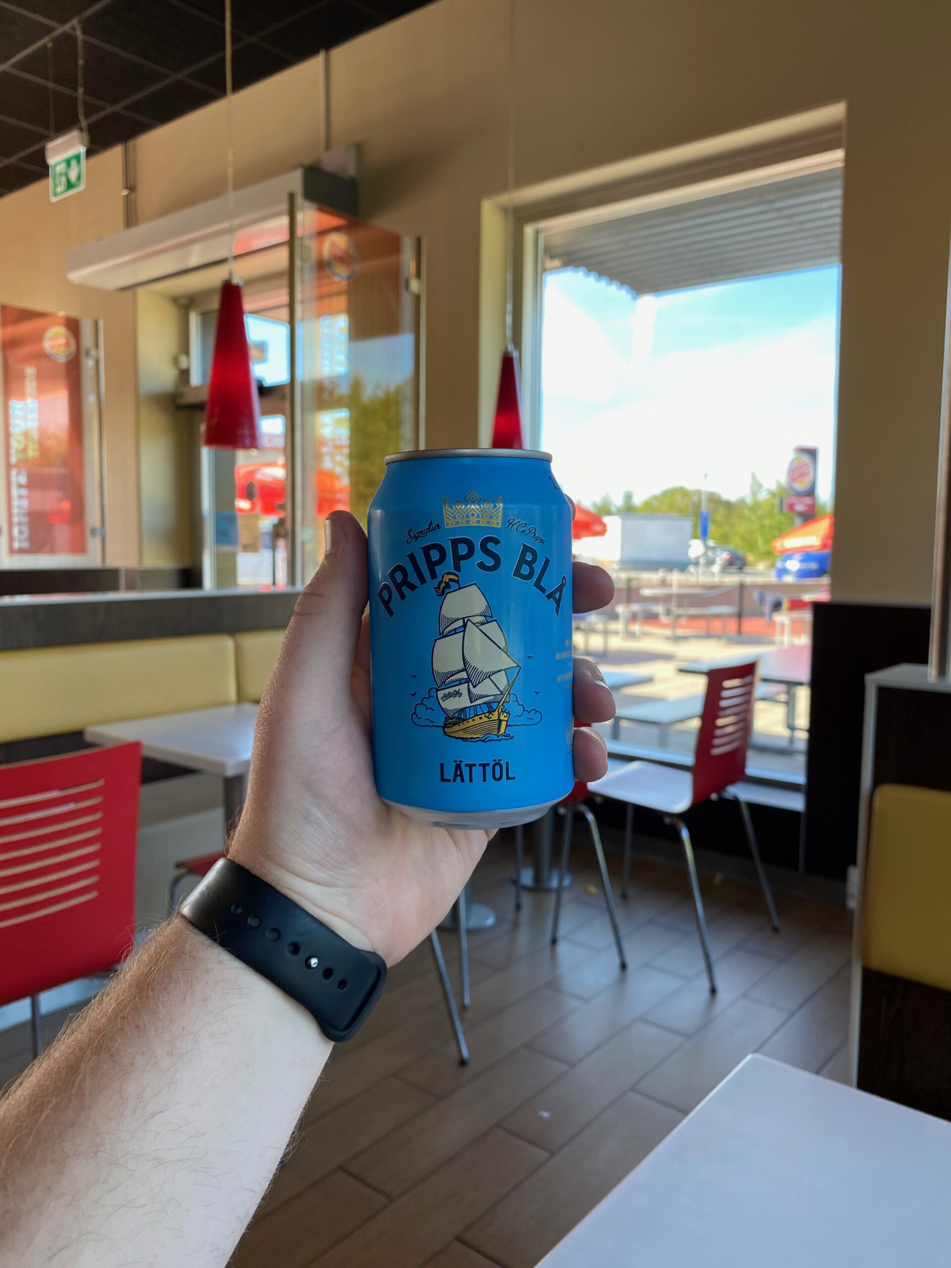 Burger King Malmö Ollebo dining area with a Pripps Blå lättöl beer held inside the restaurant as part of a Swedish road trip stop