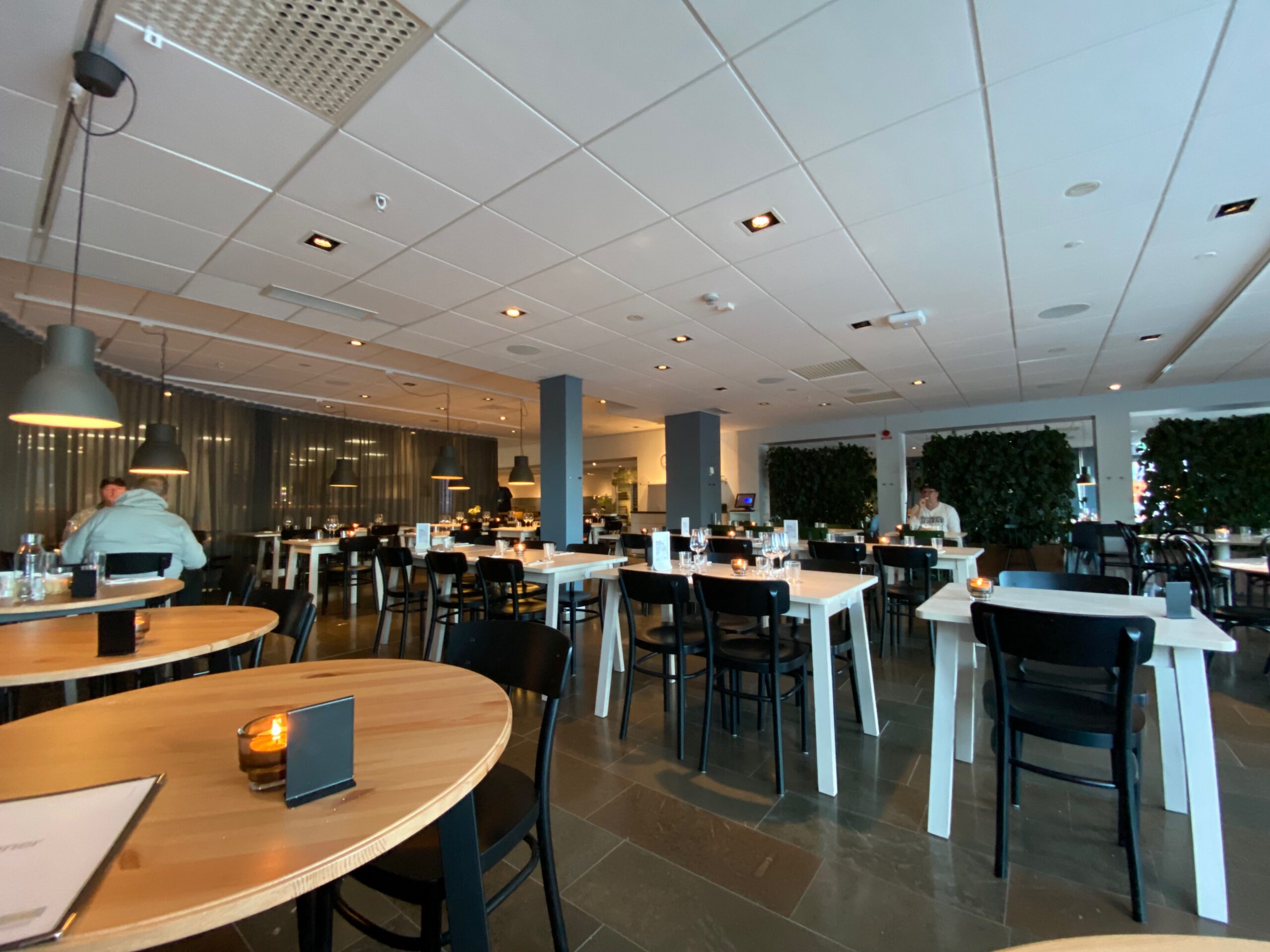 IKEA Hotell Restaurant Älmhult interior with modern Scandinavian dining area, wooden tables, soft lighting and a calm, cozy atmosphere inside the hotel restaurant