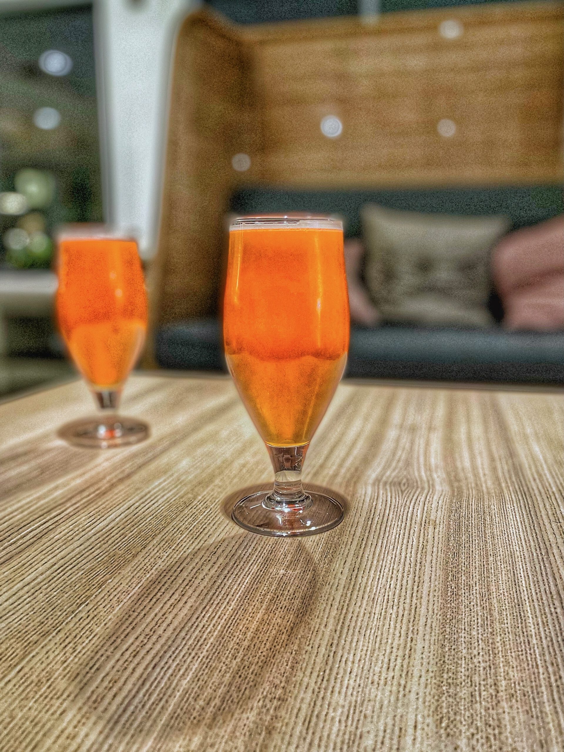 Local Swedish craft beer served in a glass at IKEA Hotell Älmhult lounge, photographed on a wooden table during a relaxed evening after dinner.