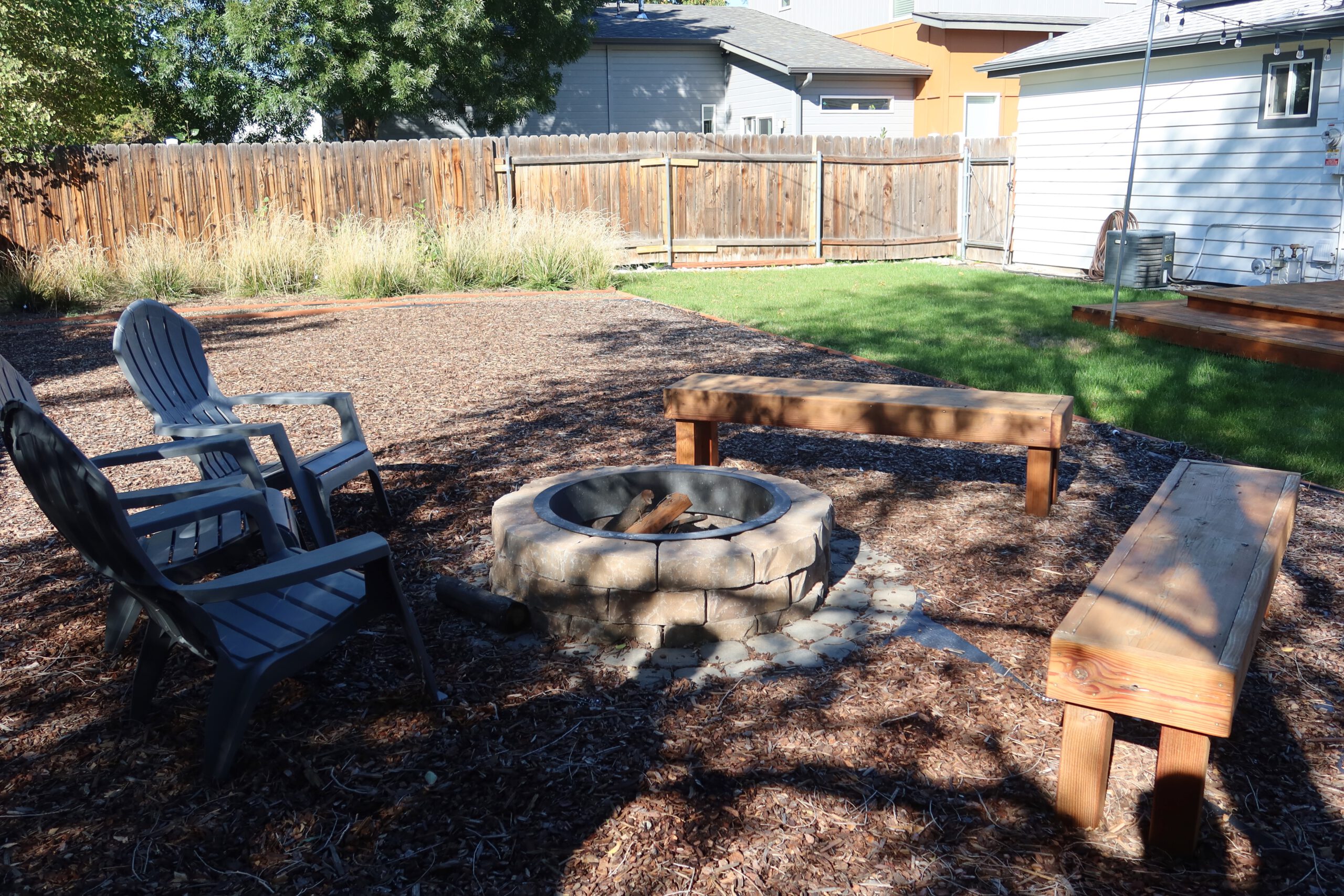 Airbnb Boise backyard with fire pit, seating area and fenced private garden