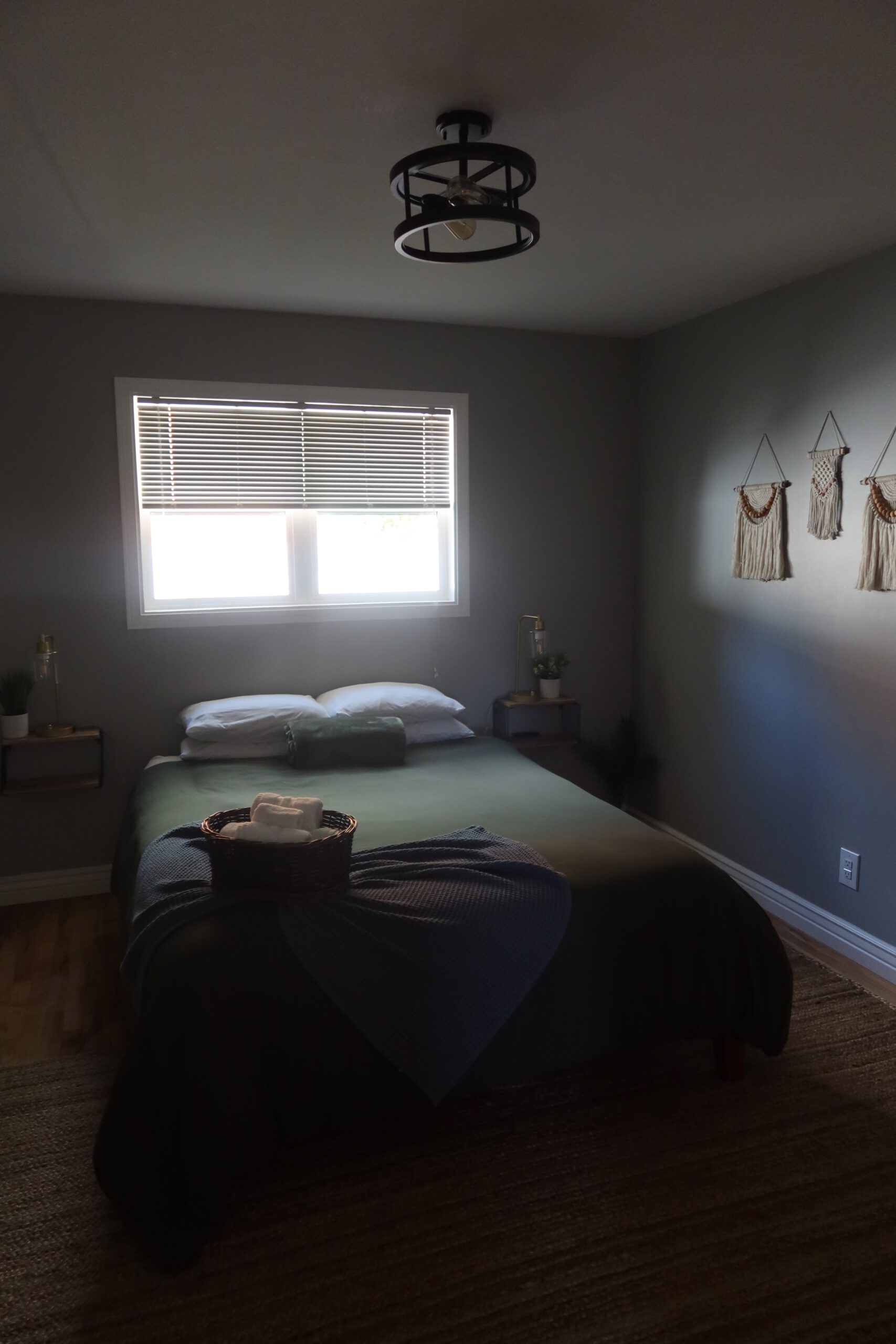 Airbnb Boise bedroom with queen size bed, soft lighting and calm modern interior