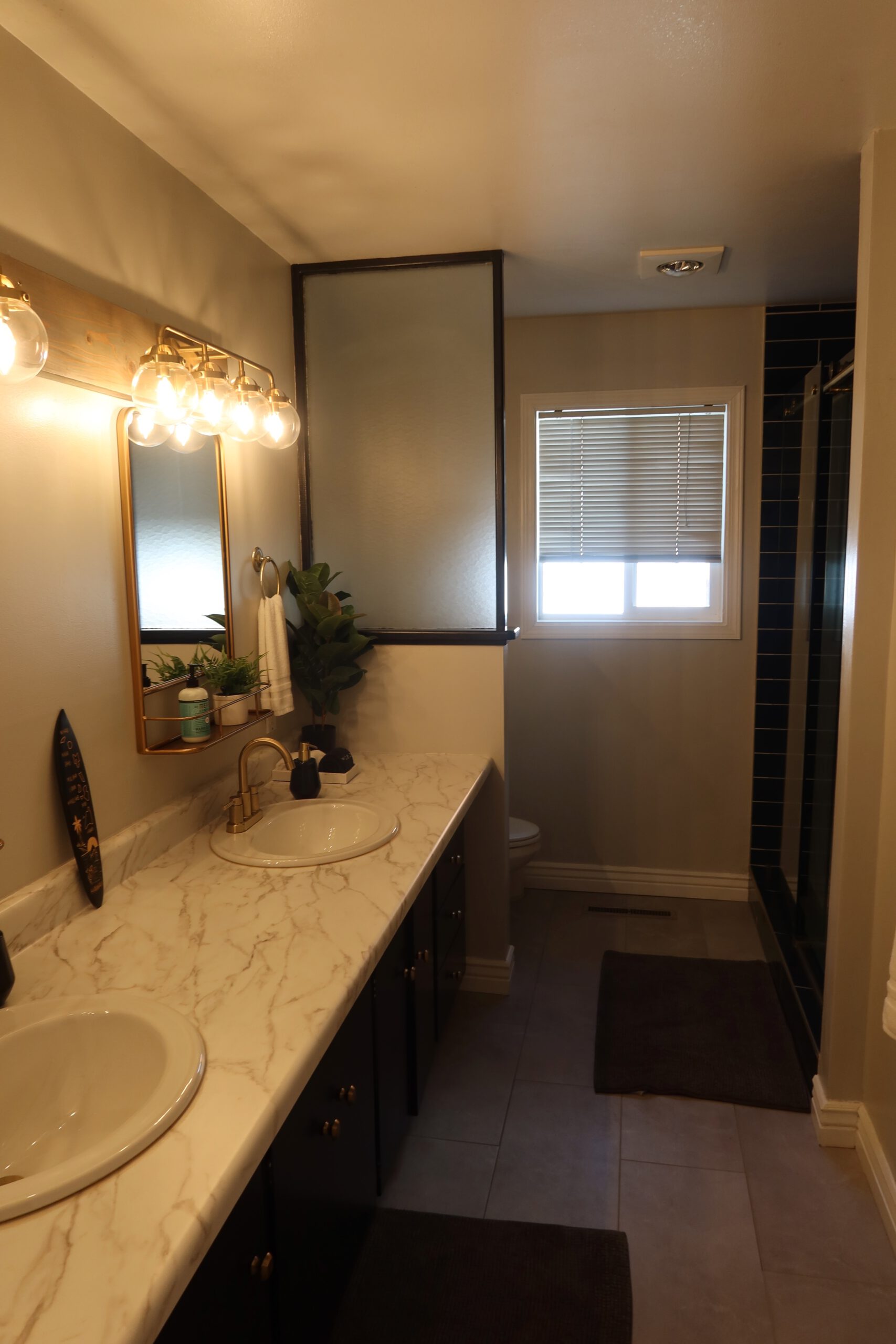 Airbnb Boise bathroom with double sink, modern vanity and walk in shower