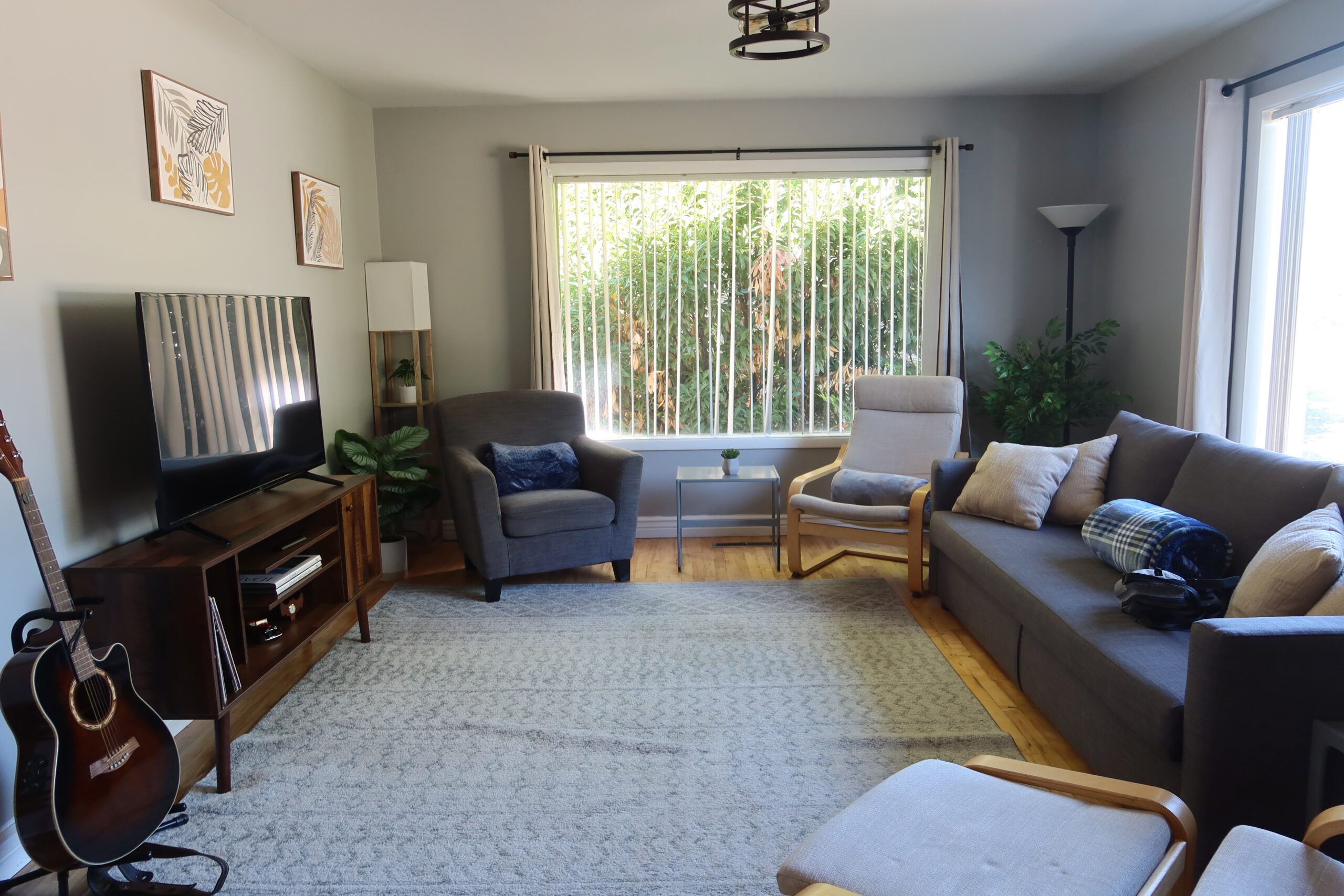 Airbnb Boise living room with sofa, seating area, large TV and cozy interior