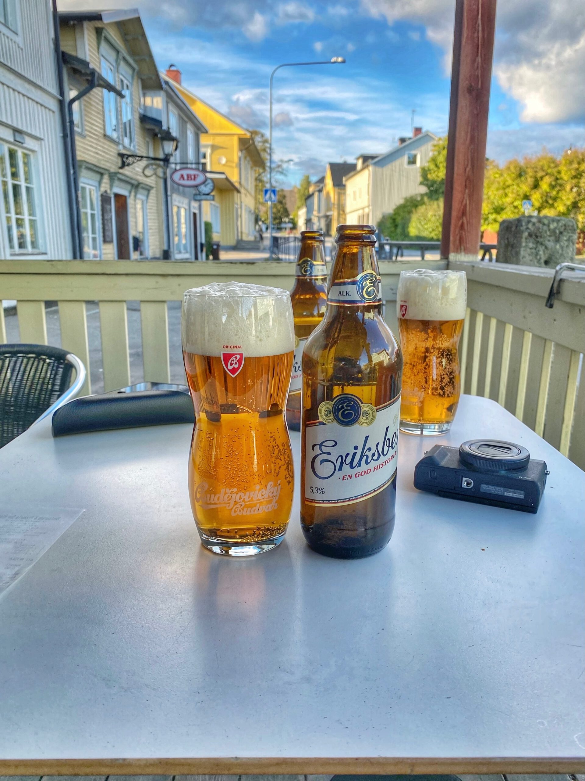 Sun Rise Nordmaling outdoor table with cold Swedish beer including Eriksberg lager and draft beer glasses on the terrace of a small town pizzeria in northern Sweden