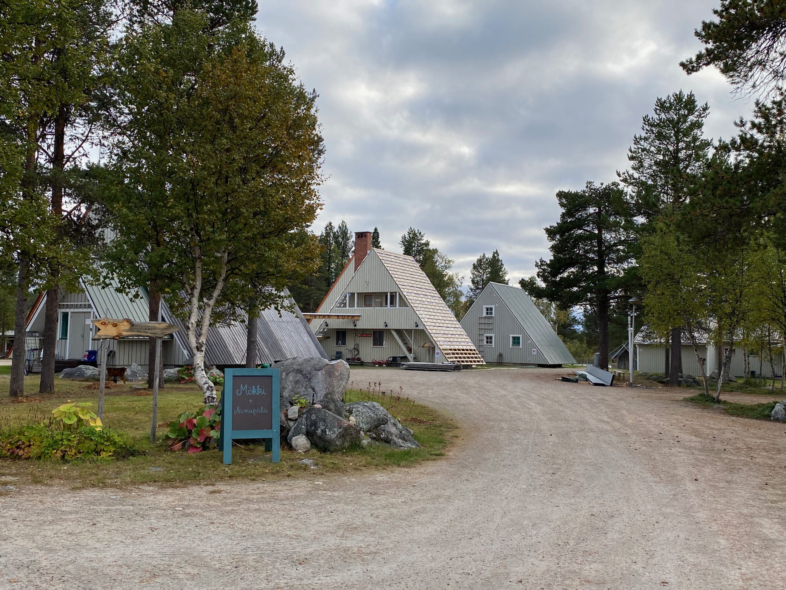 Hetan Kota Enontekiö Finland accommodation area with multiple triangular cabins surrounded by forest, quiet Lapland wilderness atmosphere