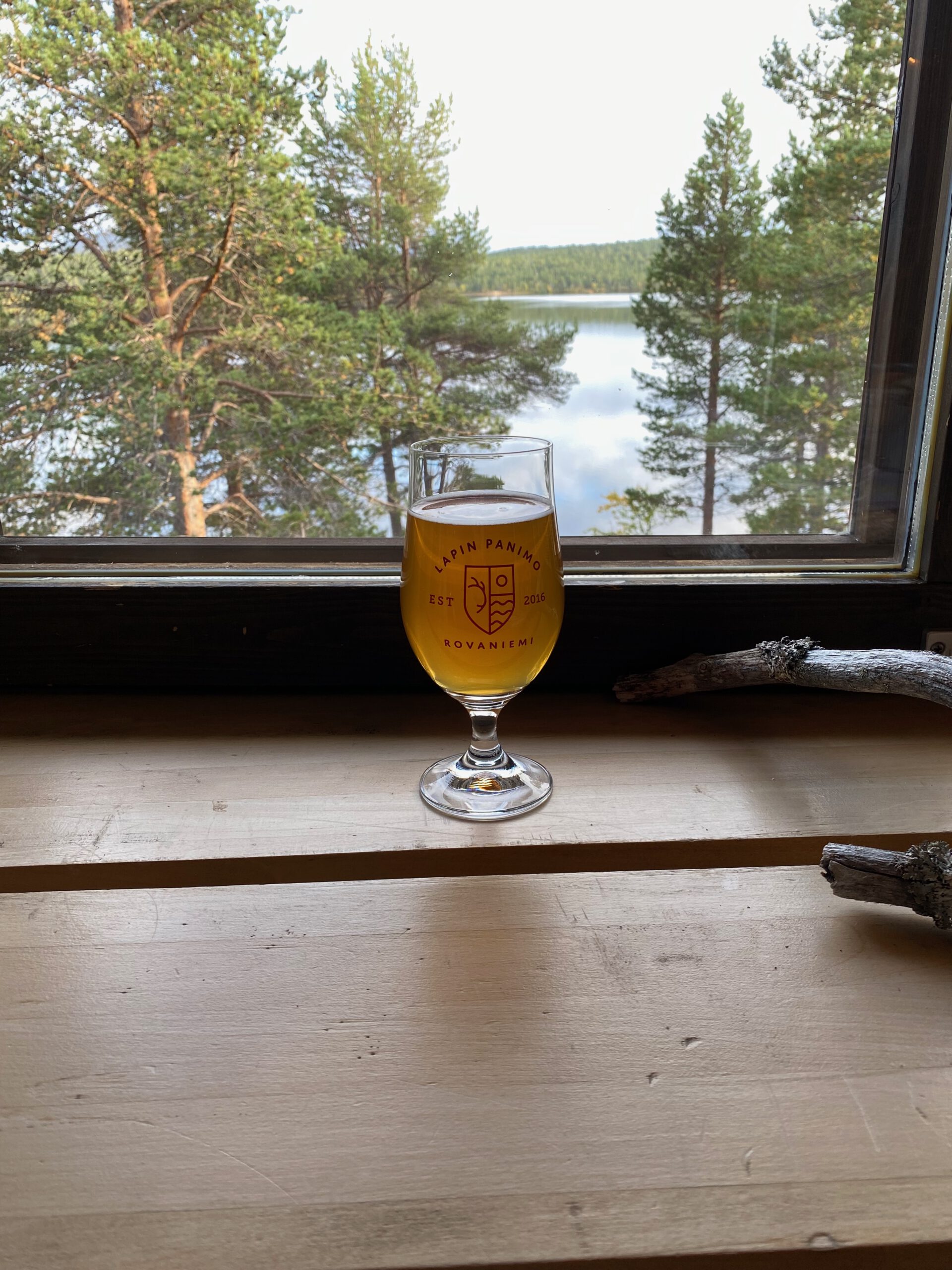 Lapland Hotels Hetta restaurant local Finnish beer by the window with lake view and forest scenery in Enontekiö