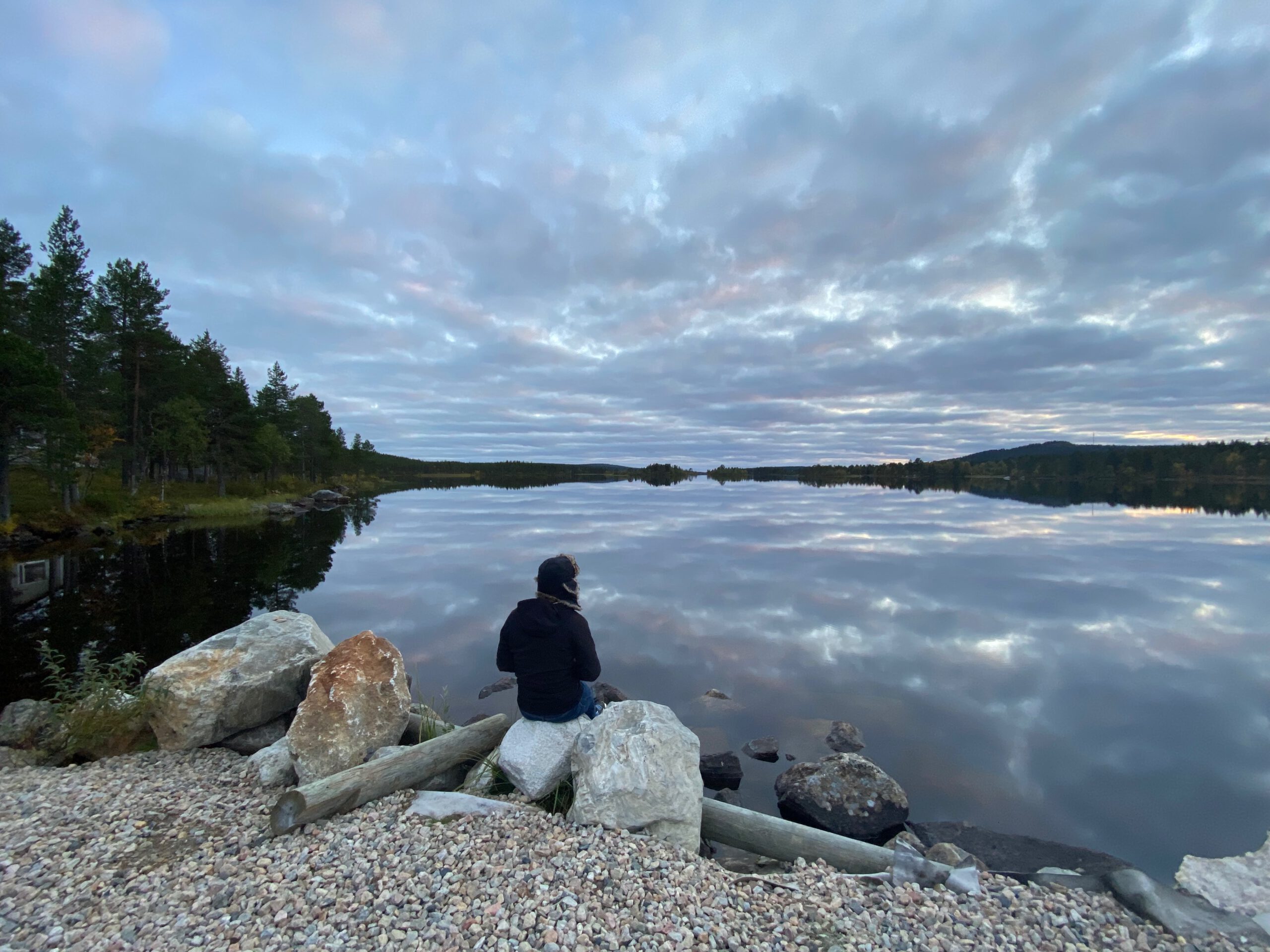 Hetan Kota Enontekiö Finland serene evening lakeside scene with Peter Smit sitting by the water, deep silence in Finnish Lapland