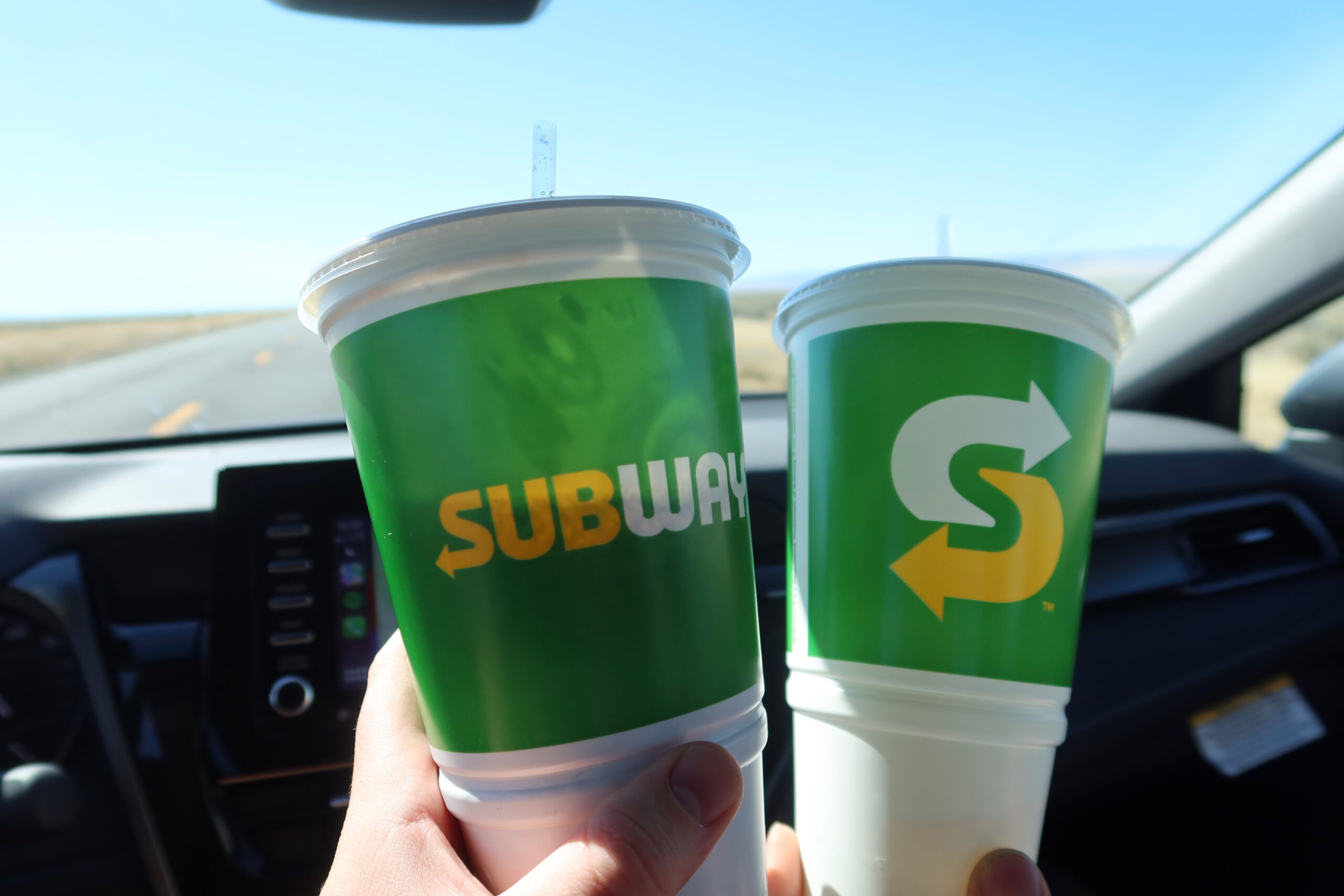 Subway soft drinks from Subway McDermitt Nevada held inside a car on US 95 during a quiet Nevada road trip