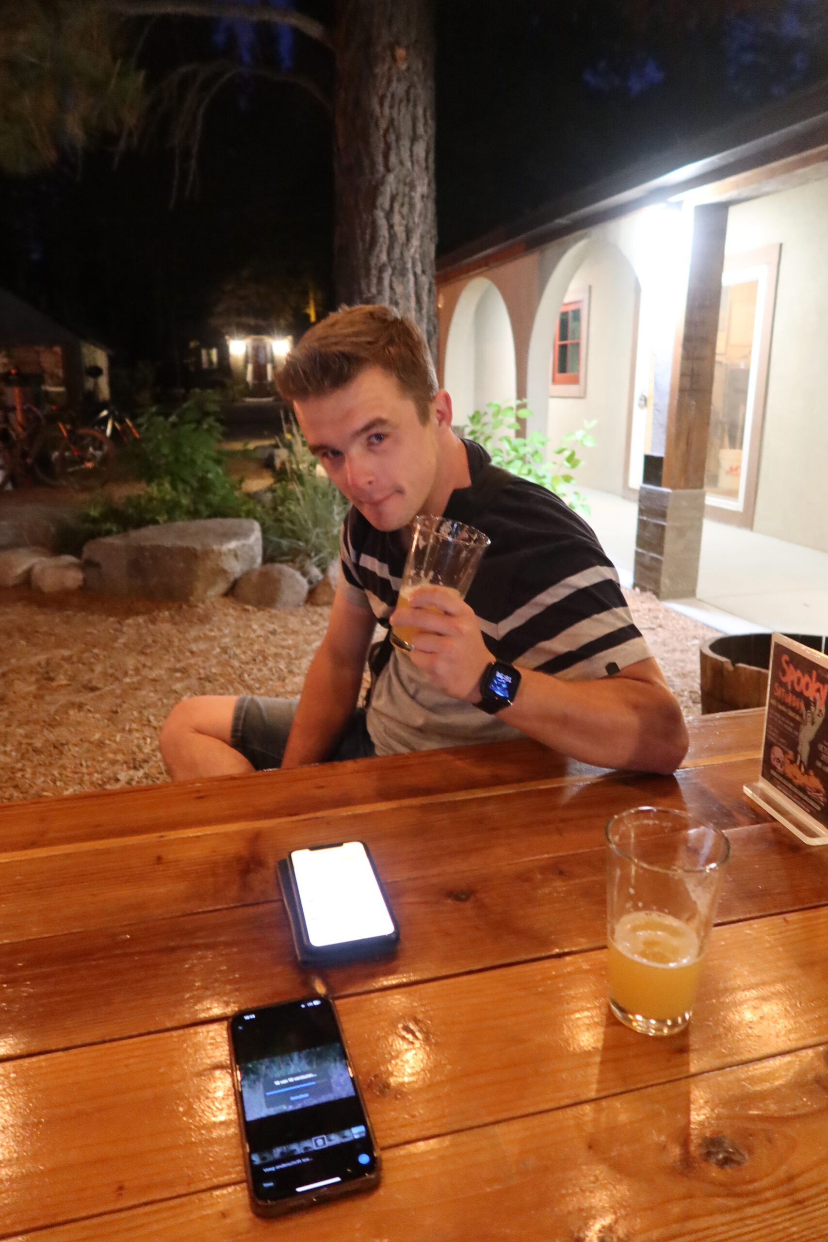 Peter Smit / AltijdPeter / peter010boy enjoying a craft beer at Bear Belly Brewing Company in Kings Beach California, seated at an outdoor wooden table during a relaxed Lake Tahoe evening