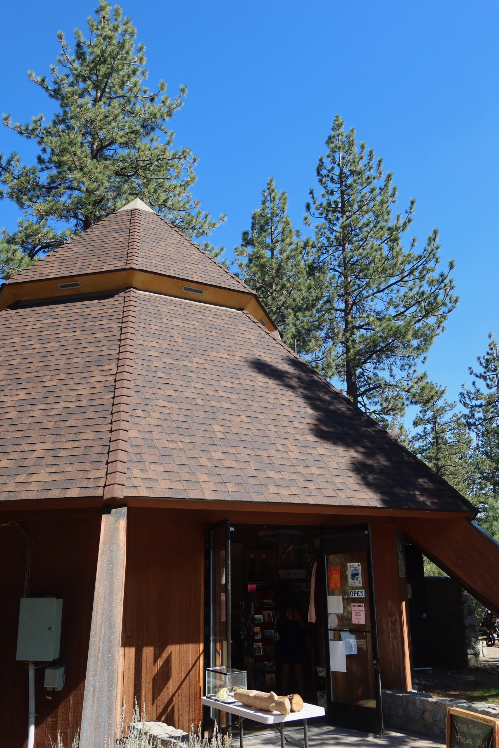 Emerald Bay State Park visitor center surrounded by pine trees under a clear blue sky near Lake Tahoe, California.