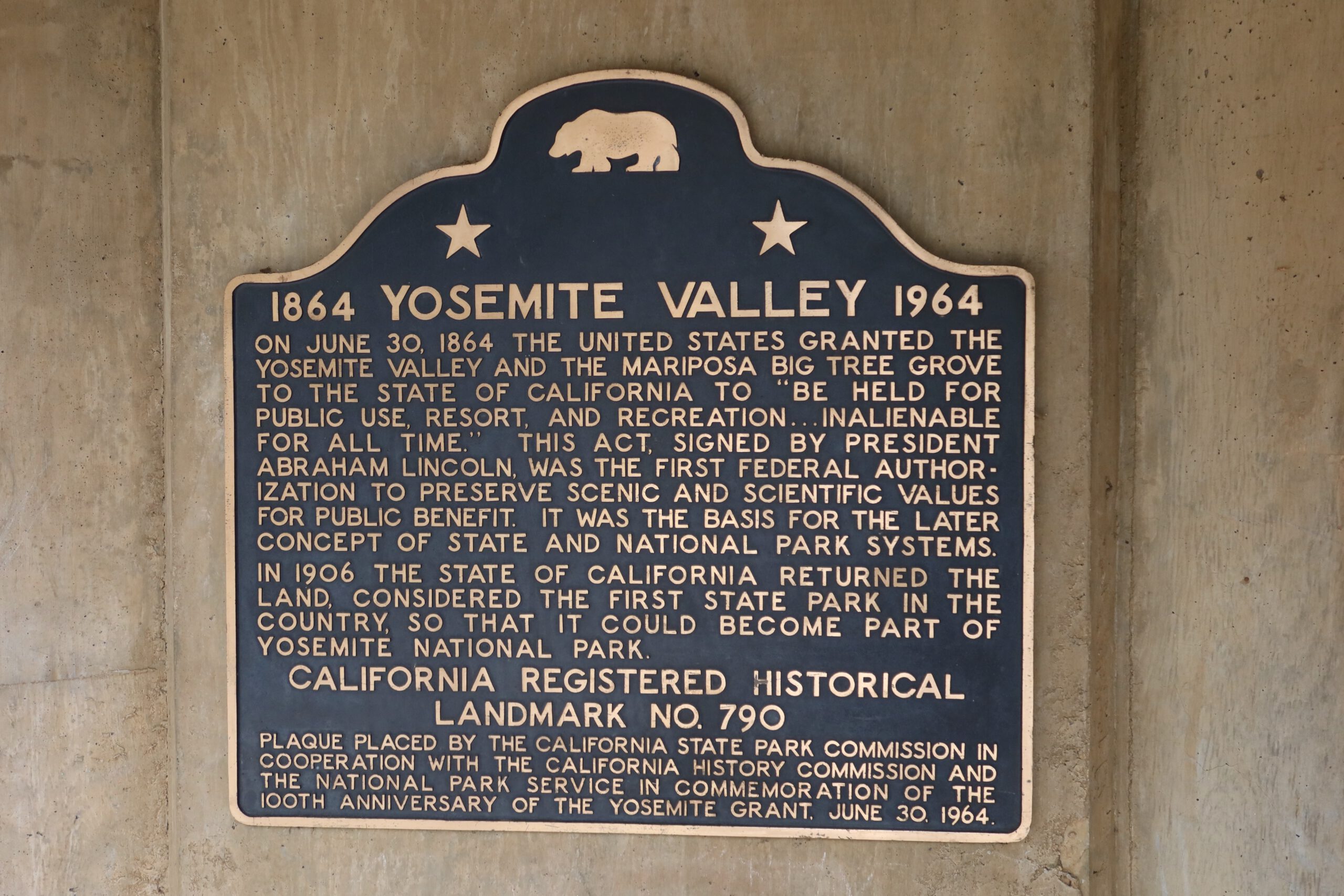 Yosemite National Park historic plaque in Yosemite Valley explaining the Yosemite Grant of 1864 and the foundation of the American national park system