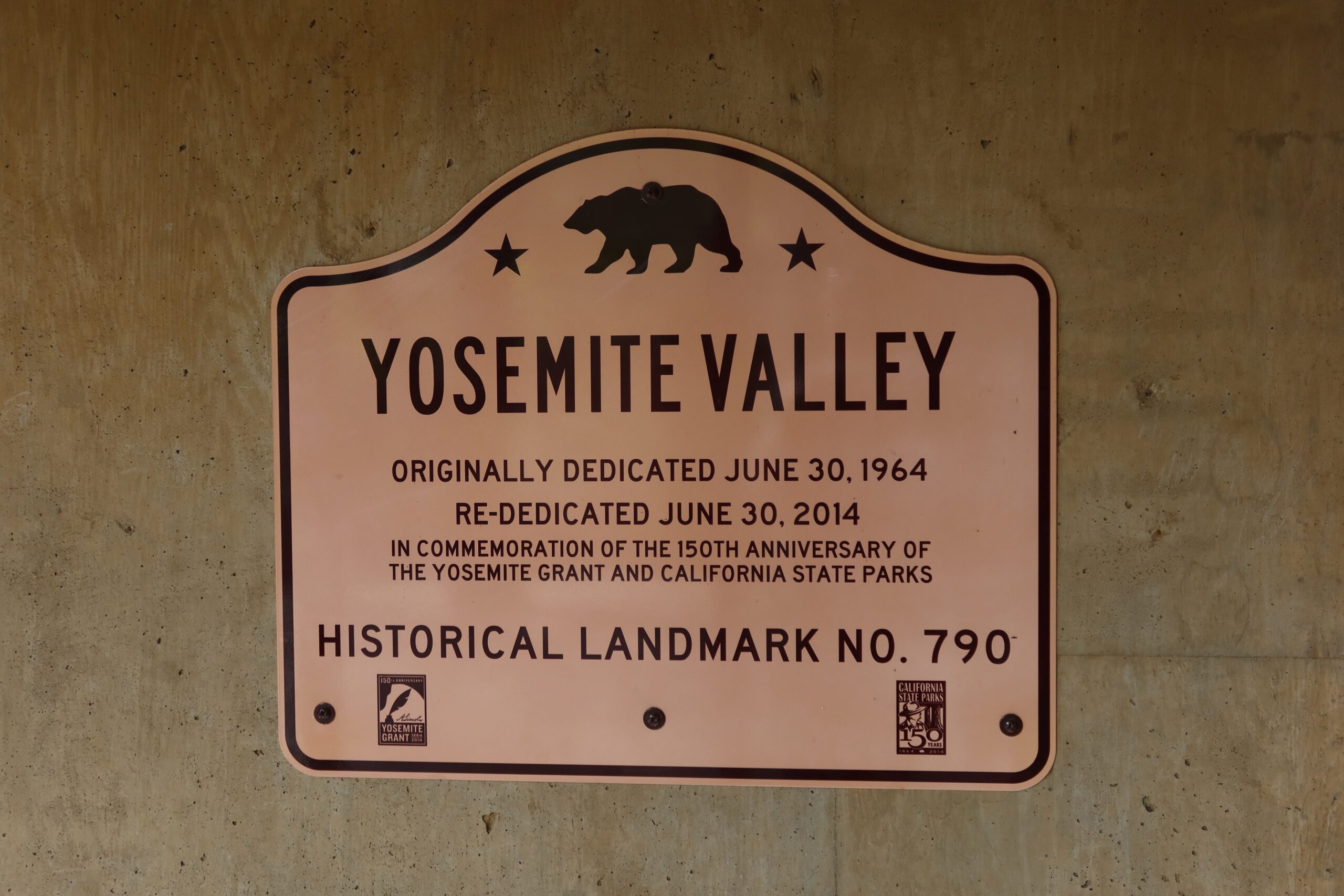 Yosemite National Park historical landmark sign in Yosemite Valley, dedicated to the Yosemite Grant and the origins of protected nature in California
