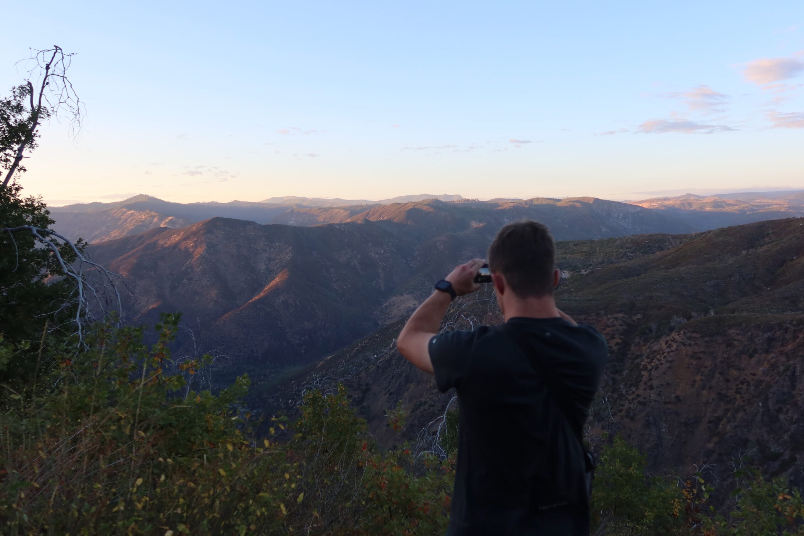 Yosemite National Park scenic mountain view at sunset with traveler, Peter Smit, photographing the Sierra Nevada landscape from a viewpoint