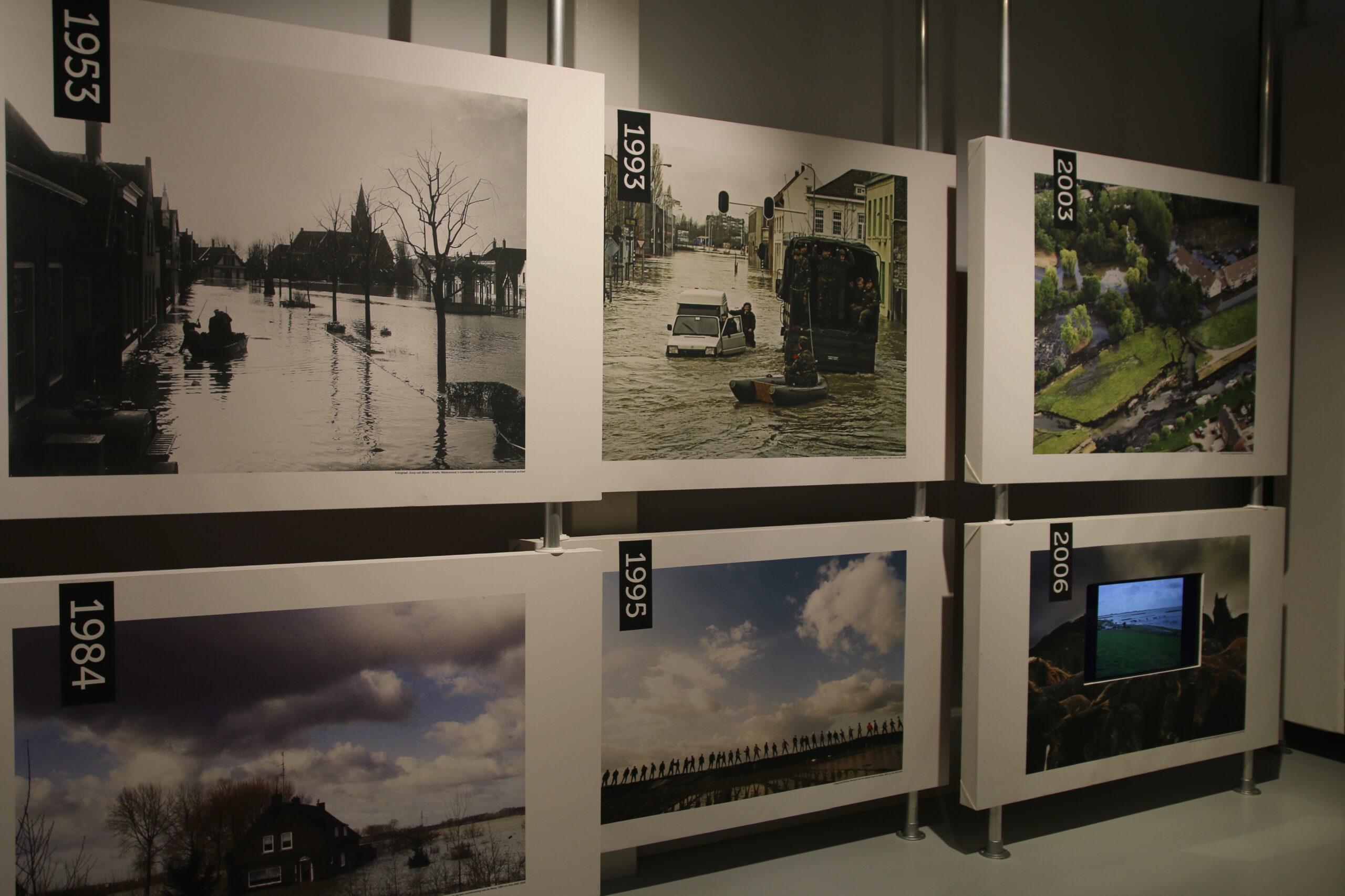 Afsluitdijk Wadden Center exhibition panels displaying historic flood events and climate change impact along the Afsluitdijk
