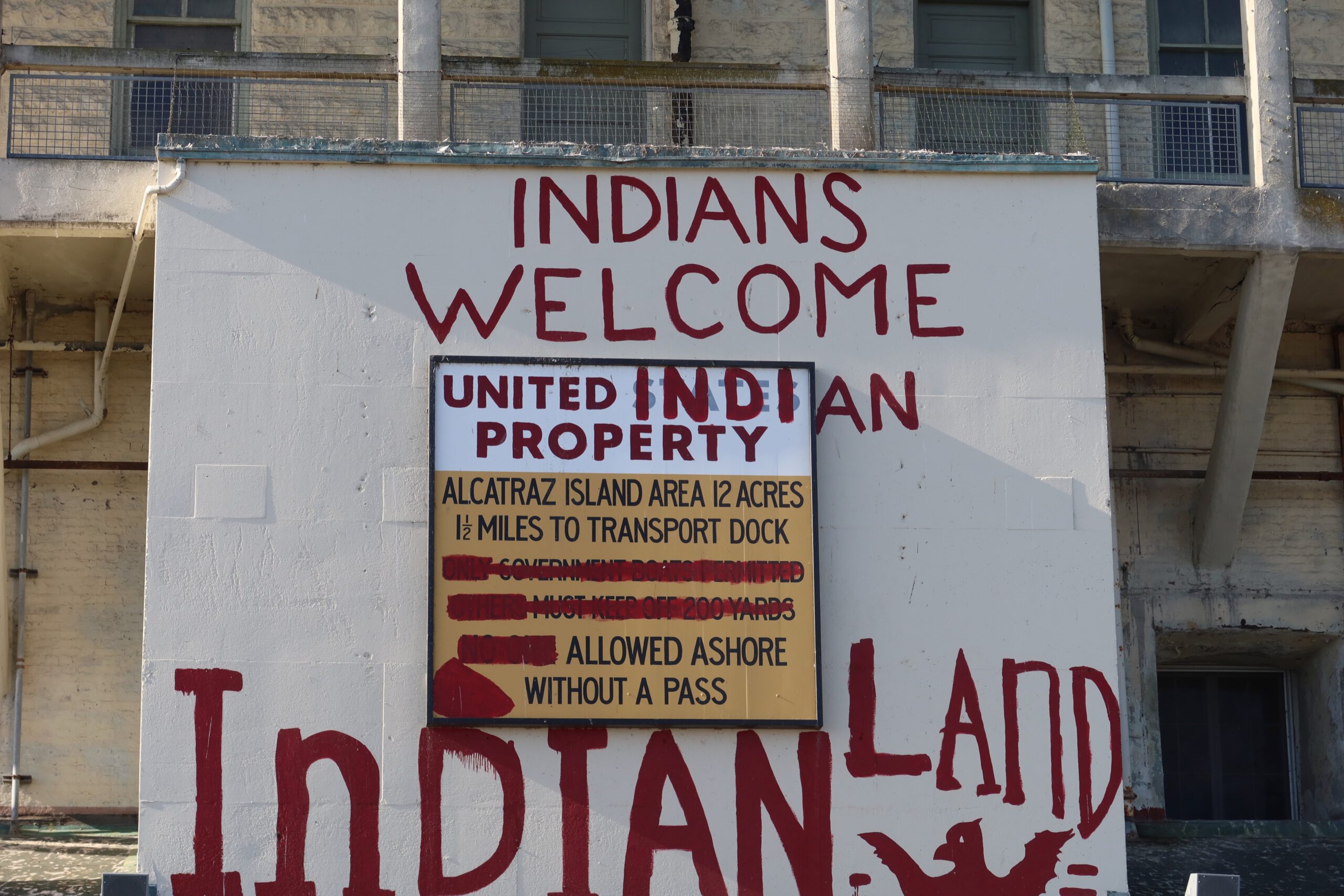 Indians Welcome sign on Alcatraz Island referencing the Native American occupation and Indian Land movement painted on historic prison walls