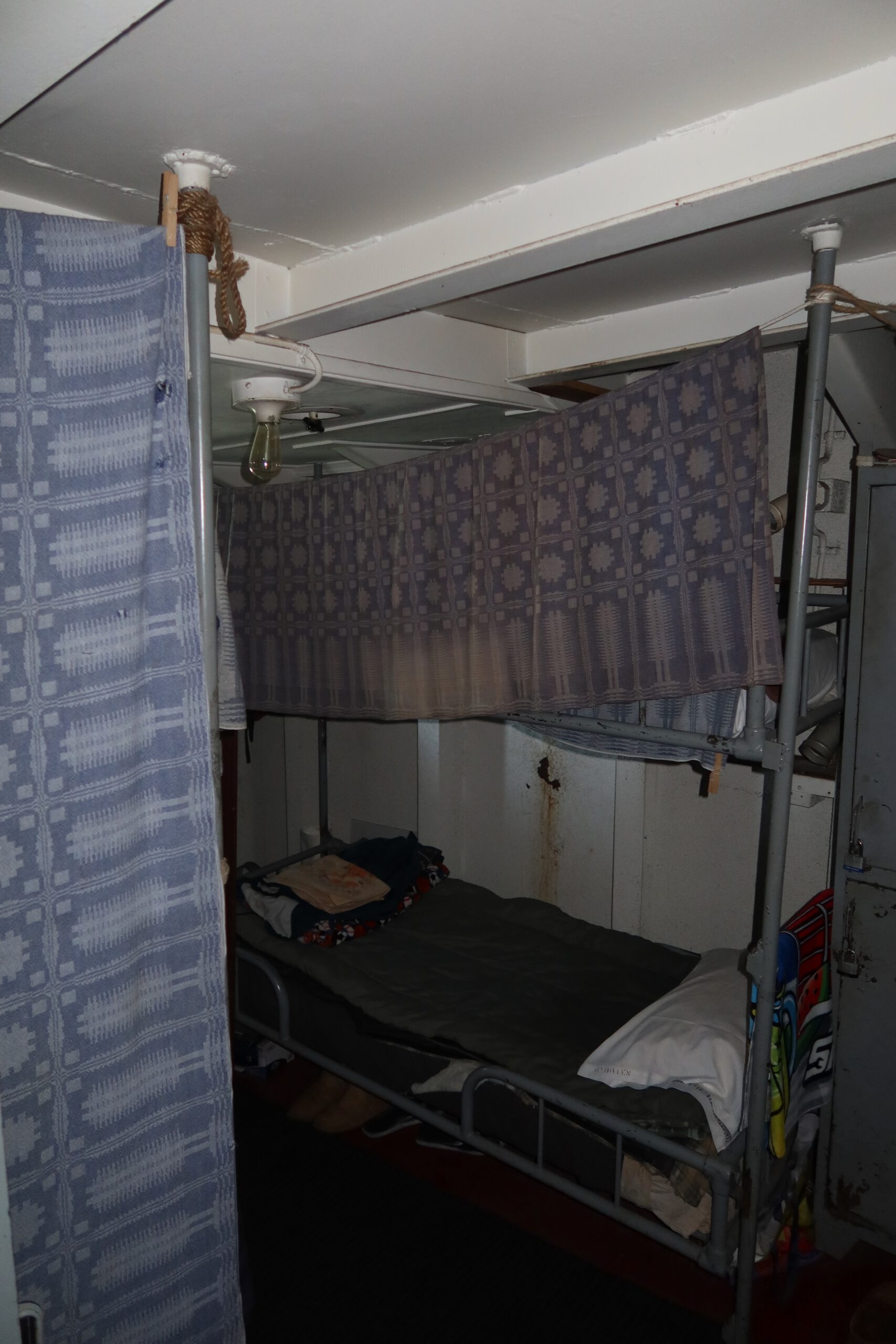 SS Jeremiah O'Brien restored sleeping area with bunk beds and privacy curtains, revealing daily life aboard a World War II Liberty ship