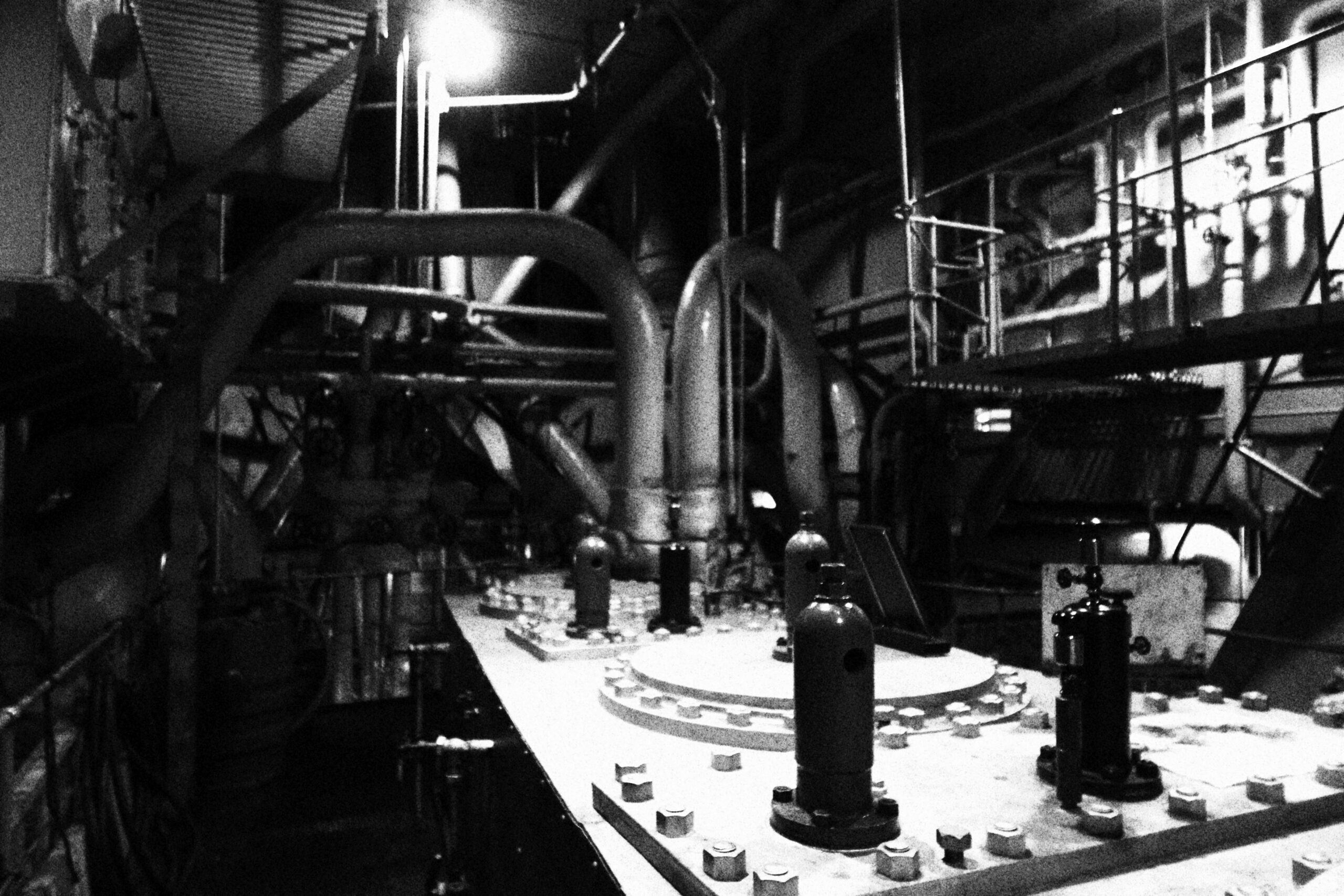 SS Jeremiah O'Brien engine room showing massive original pipes, valves and machinery inside the World War II Liberty ship, highlighting industrial wartime engineering