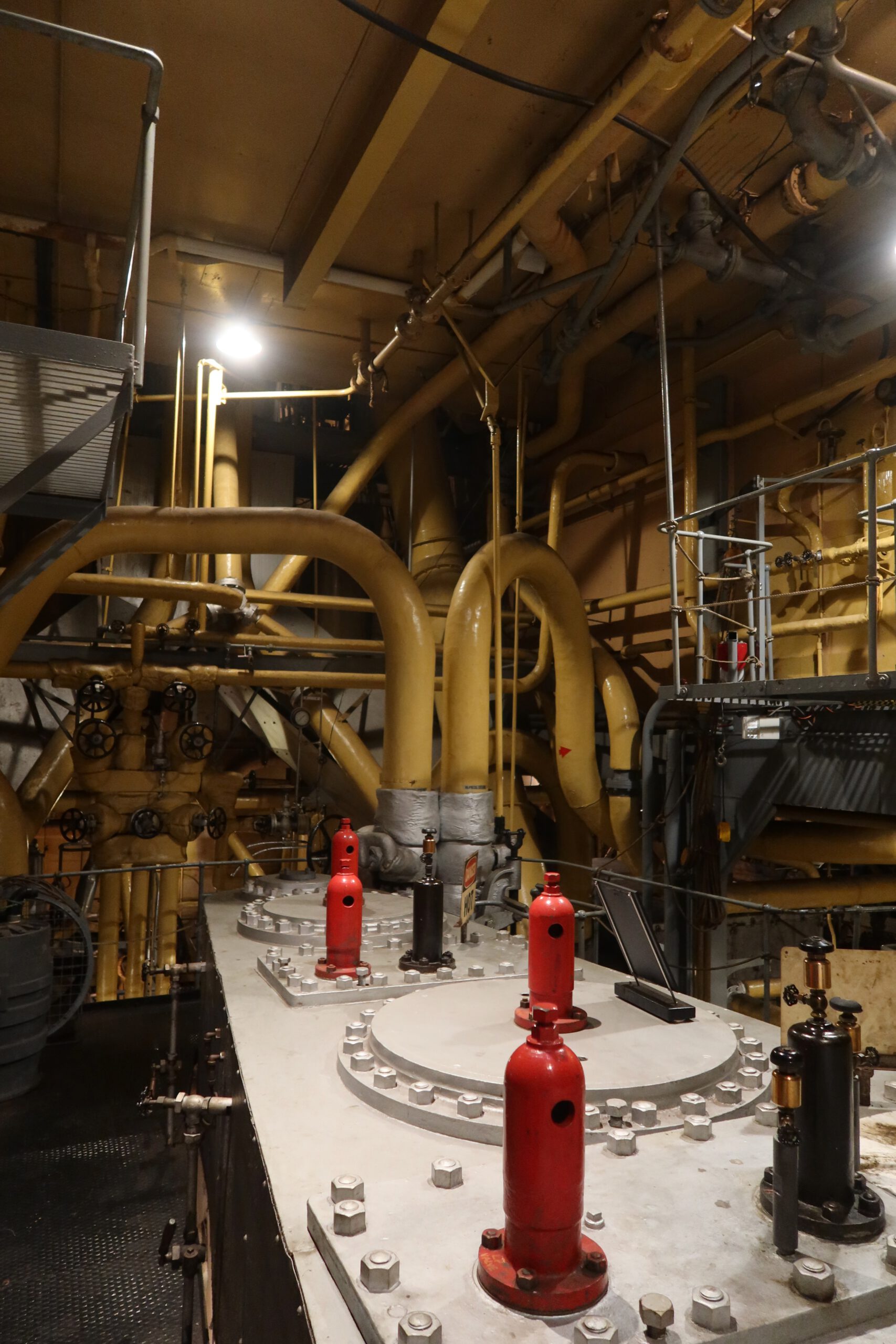 Main engine components and safety valves inside the SS Jeremiah O’Brien engine room, highlighting authentic WWII Liberty Ship technology.