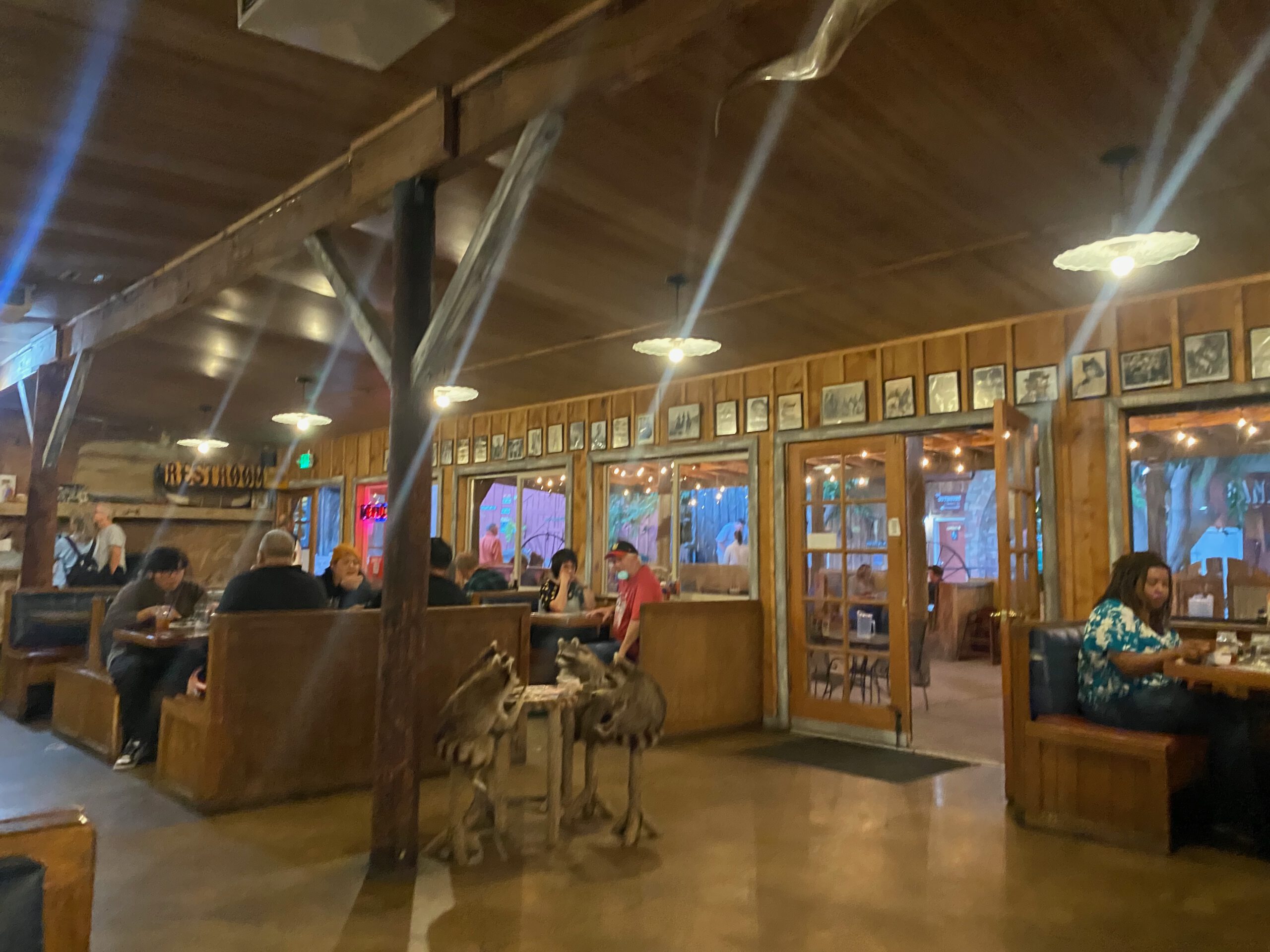 Interior of Iron Horse Kanab Utah with rustic wooden booths, western decor, warm lighting and a lively American restaurant atmosphere in downtown Kanab
