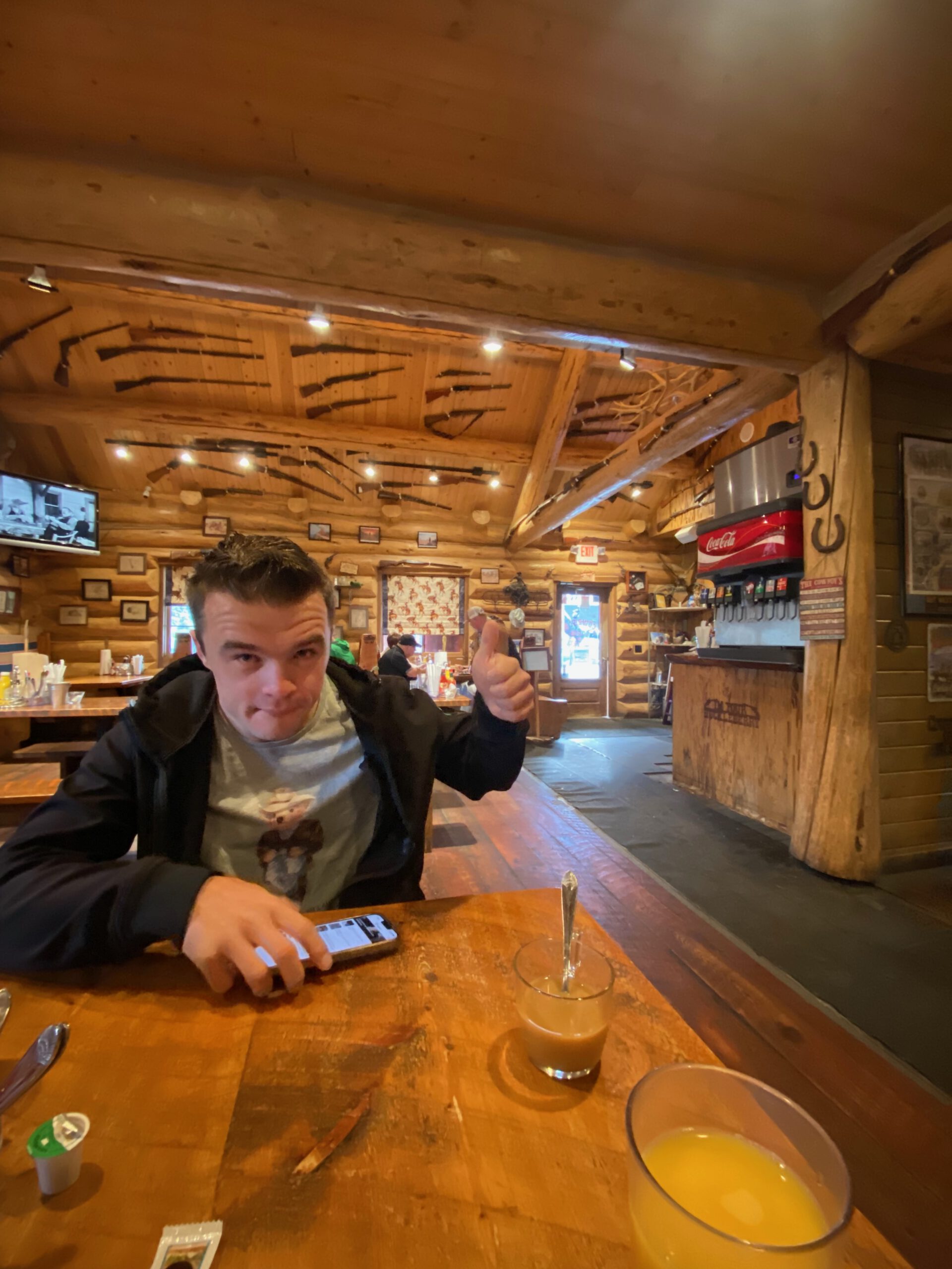 Rustic interior of Cowboy’s Lodge and Grille Gardiner, Montana, wooden lodge dining room with Western decor and cozy Yellowstone atmosphere