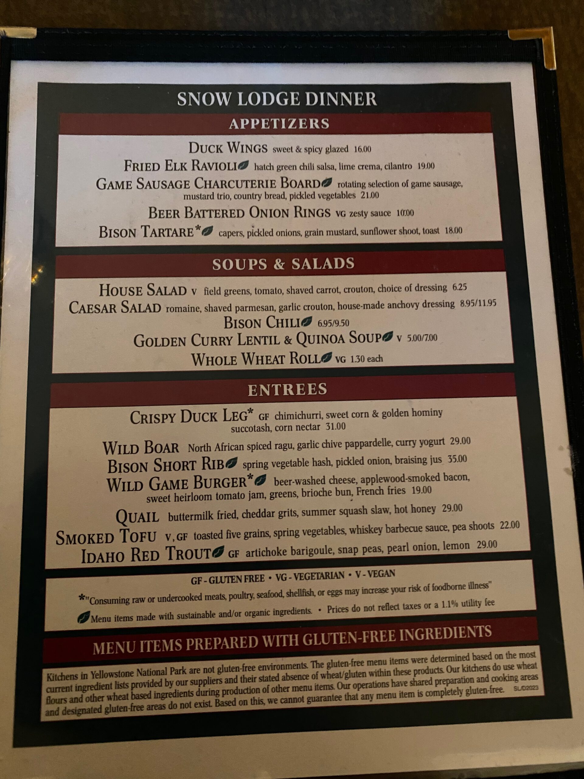 Obsidian Dining Room dinner menu at Old Faithful Snow Lodge, featuring wild game dishes like bison, duck, elk, and trout in Yellowstone National Park